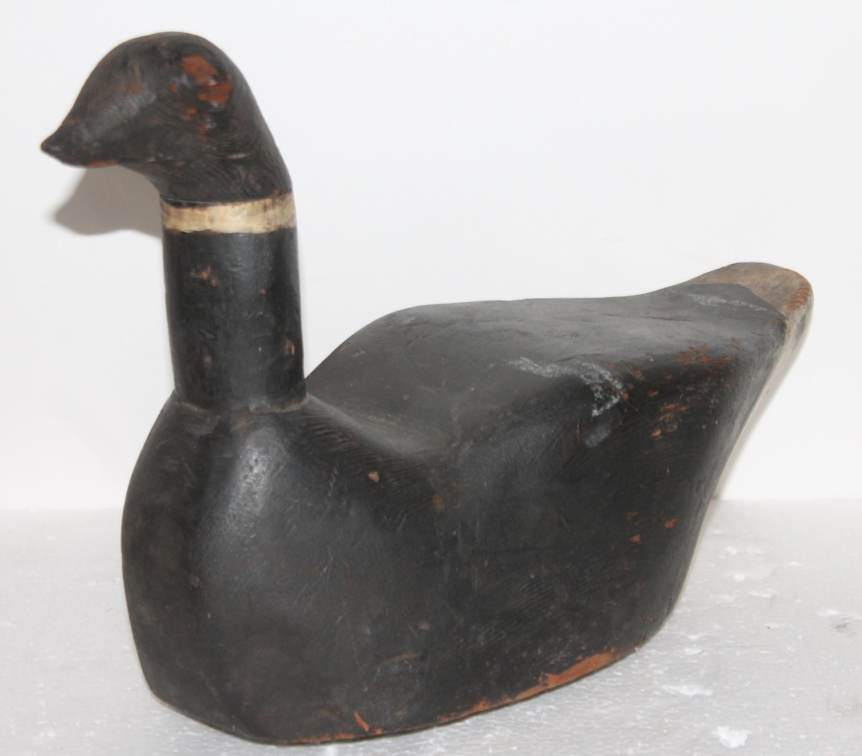 This all original black and white painted decoy is in fine condition. It is original painted surface. It was found in New England.