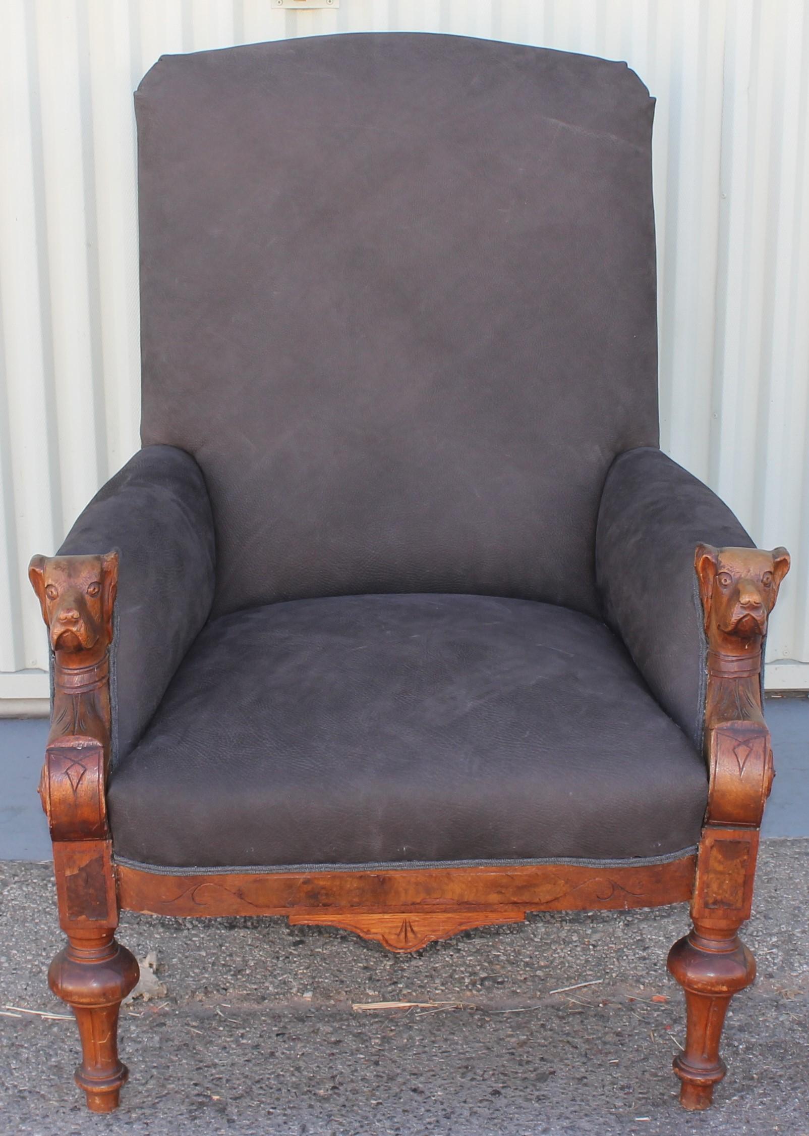 This fantastic 19thc leather chair with dog motif in the hand rests of the chair. The sides and back is in a matching black & grey plaid blanket. The frame is in walnut wood.