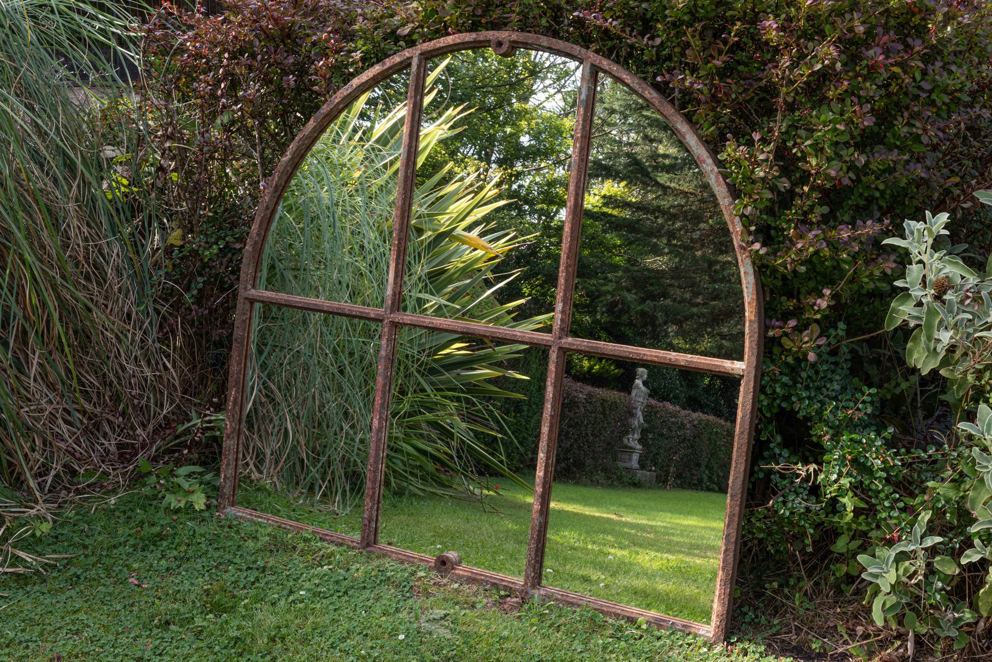 19th century cast iron arched window mirror,
circa 1870.

Large cast iron arched window mirror with original paint.

An excellent option for the garden or indoors.

Measures: 117 H x 125 W x 4 D cm.