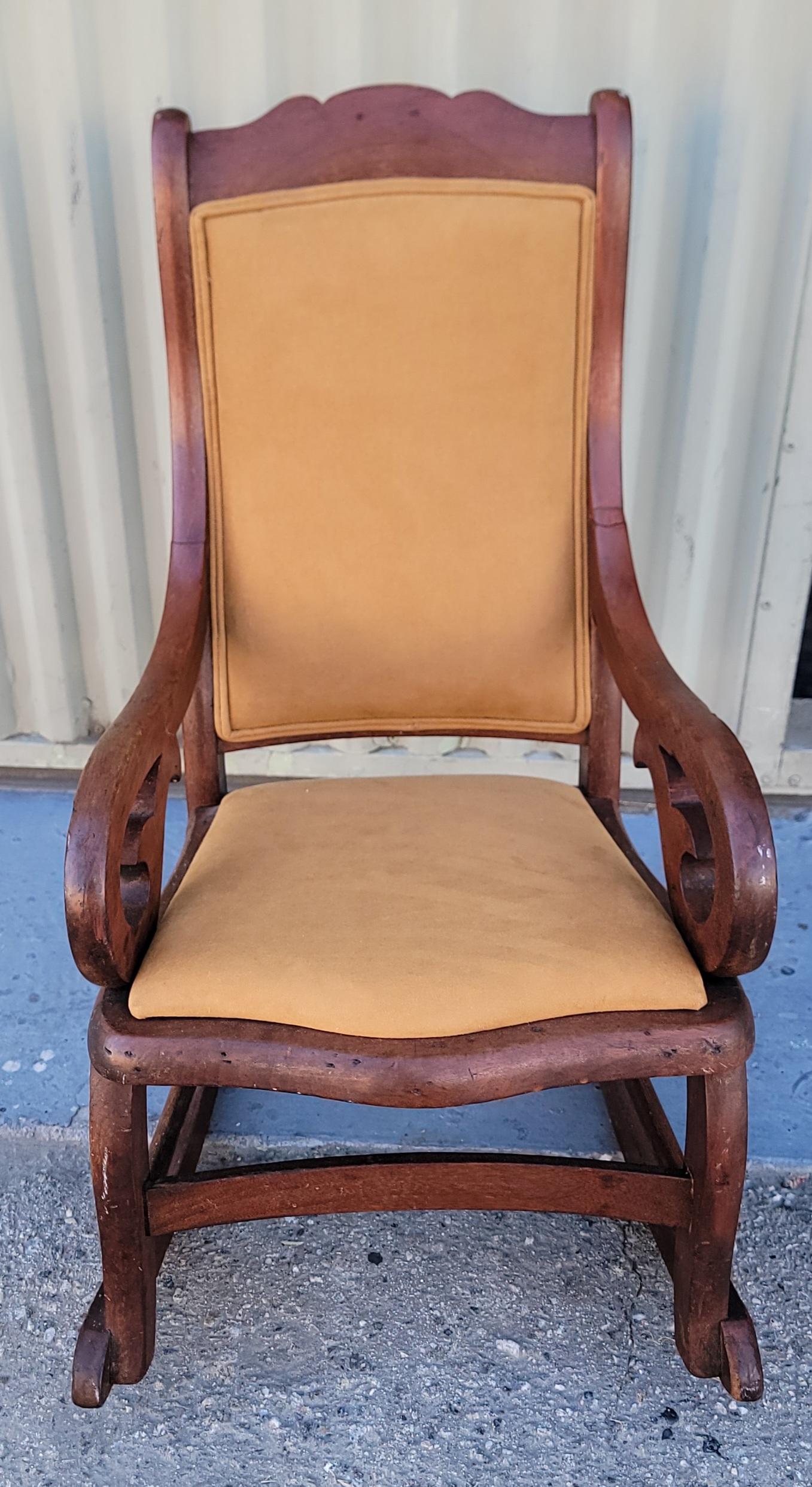 19Thc Walnut child's rocking chair upholstered in a suede leather.The condition is very good and sturdy.