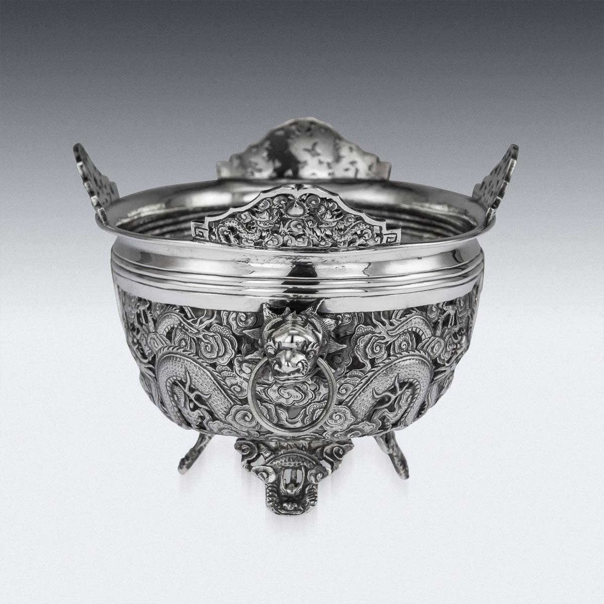 Antique late 19th century Chinese large solid silver jardinière, of oval form, applied with unusual twin dragon head handles with rings in mouth and standing on four coiled dragon feet, shaped top rim and sides decorated with pierced dragons amongst