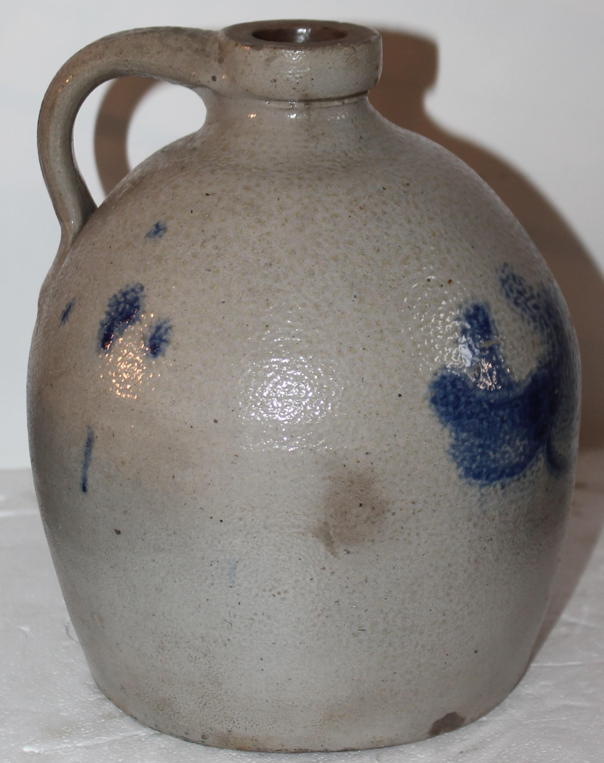 Cobalt blue painted pottery decorated floral stoneware handled jug. Measures: 9.5” high, 7” diameter.