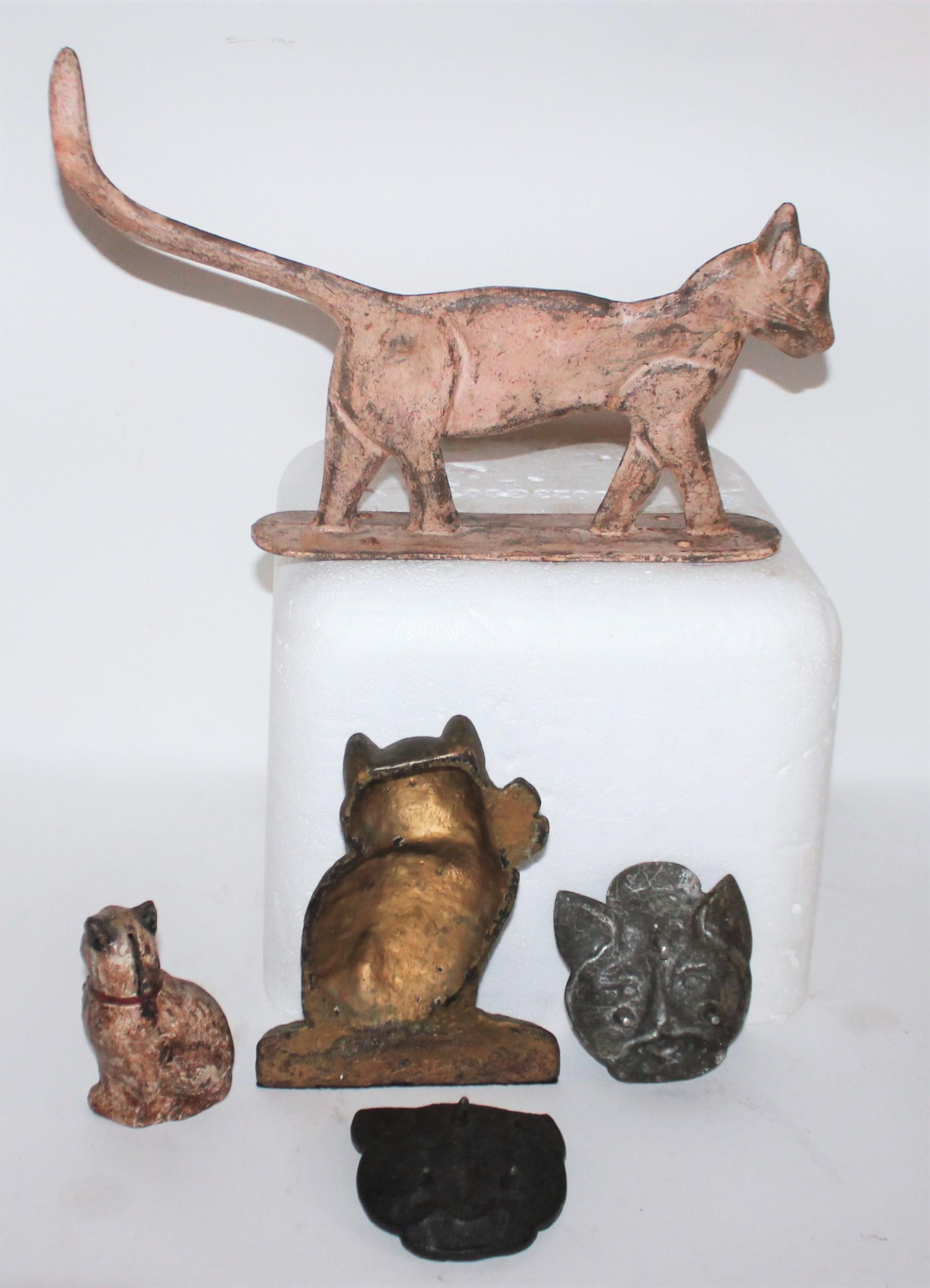 Collections of six cast iron cat items from the early 19th century.

Collection of three 19th century cast iron cats trays. These cats look like they were a give away from some iron works company. Perhaps a pot belly stove or old iron forger. They