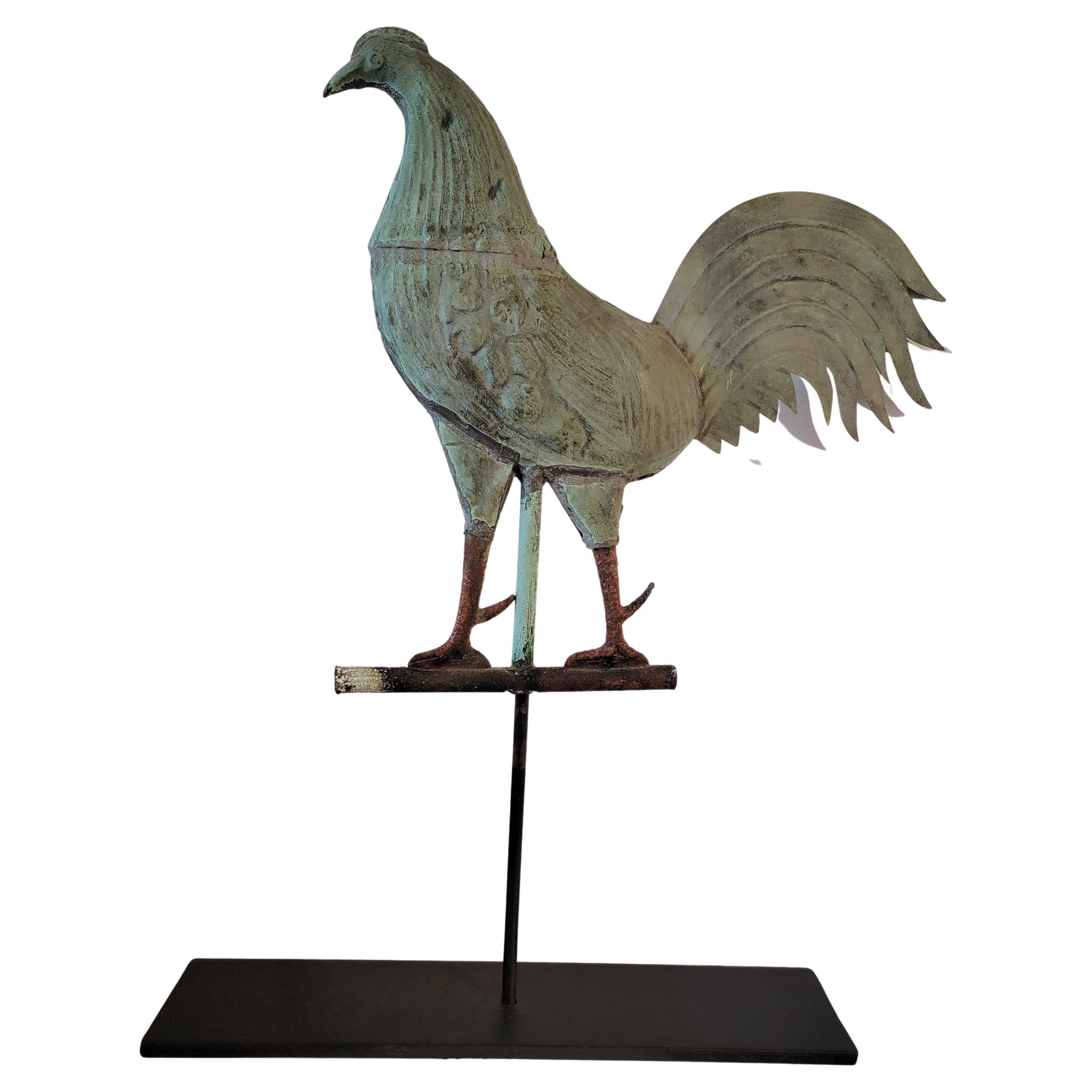 This fine early New England gamecock weather vane has an amazing undisturbed patina.On one side is a couple of bullet shot marks,but not all the way through.The feet & legs are a warn & patinaed forged iron. Such a great presents. This comes from a