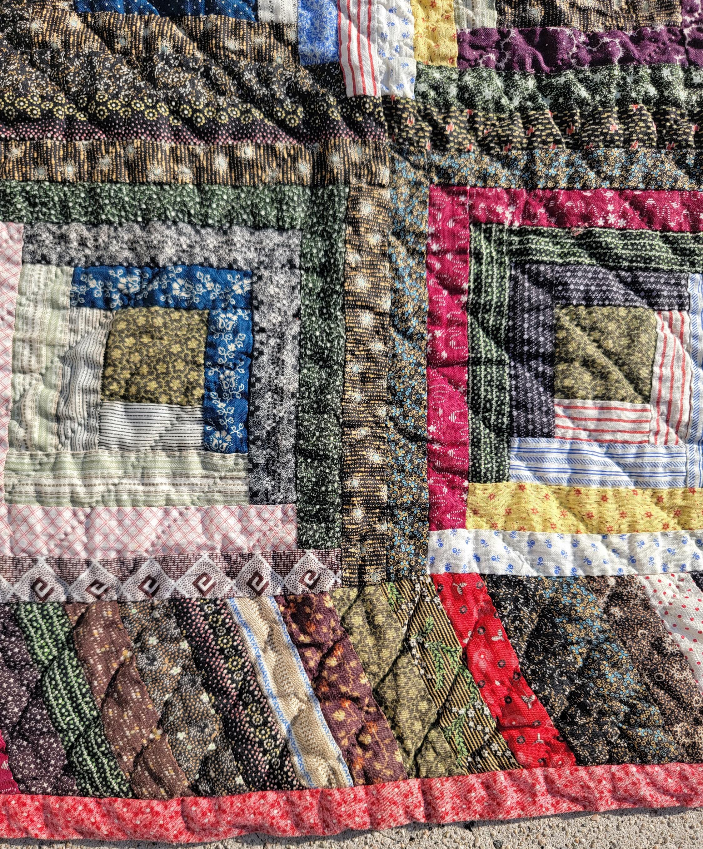 19Thc cotton log cabin quilt with striped border. This quilt was found in Lancaster County, Pennsylvania.