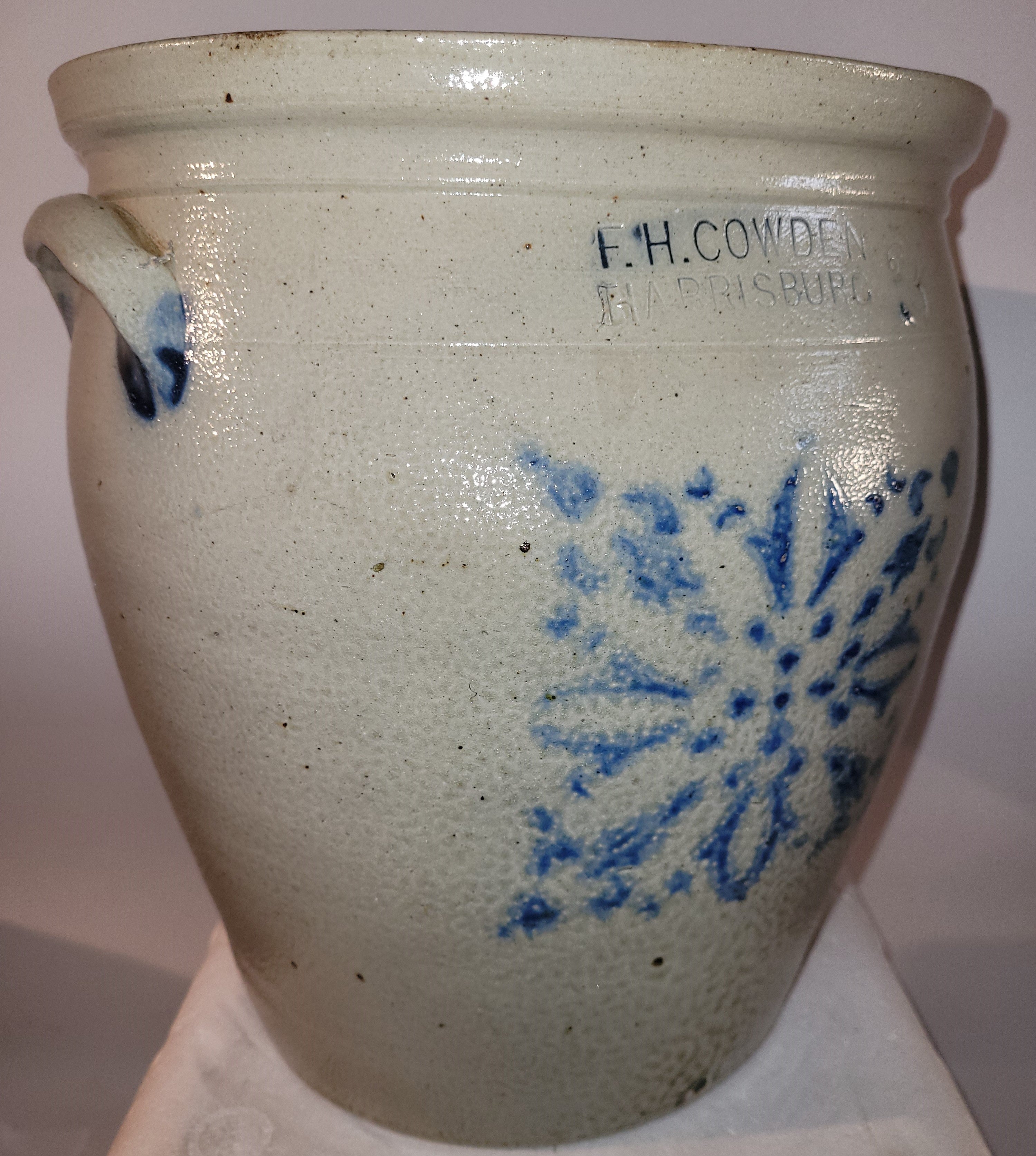 This fine decorated snow flake blue glazed Cowden & Wilcox three gallon crock is in pristine condition. This fine crock has interesting glazing and also has handles on each side.