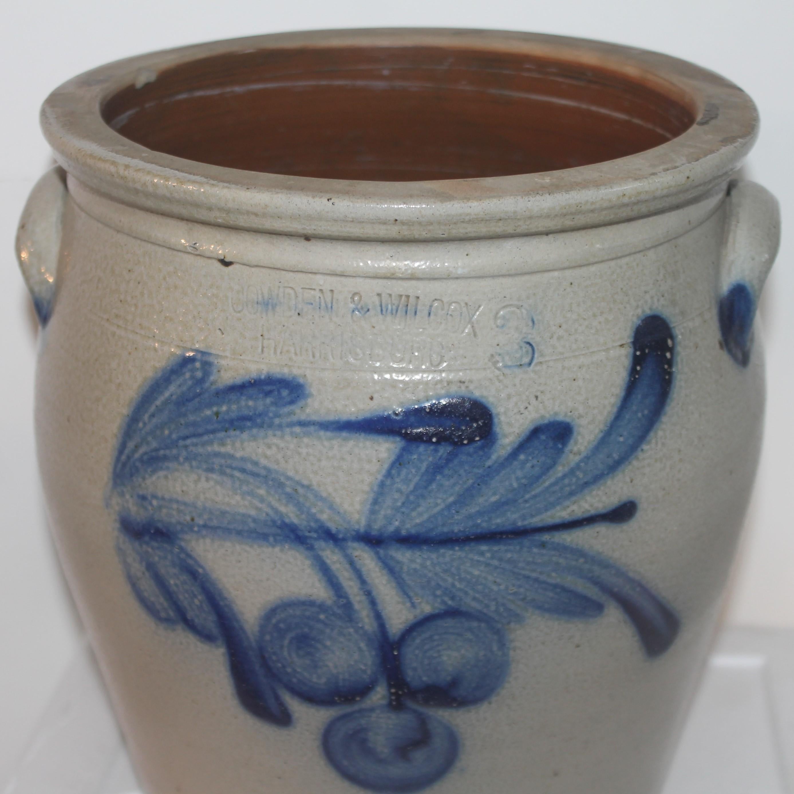 This three gallon stone ware crock with decorated cherries is from Harrisburg, Pennsylvania. The maker is Cowden & Wilcox and is signed on the front above the hand painted decoration. The crock is double handled and in mint condition.
