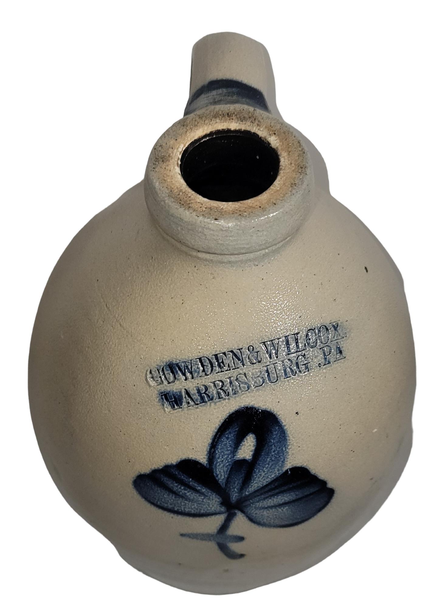 This 19thc decorated stoneware jug is in fine condition. It has a little simple flower design in indigo blue decoration. This jug is stamped Cowden & Wilcox ,Harrisburg,Pennsylvania.It was made around 1870-1880.