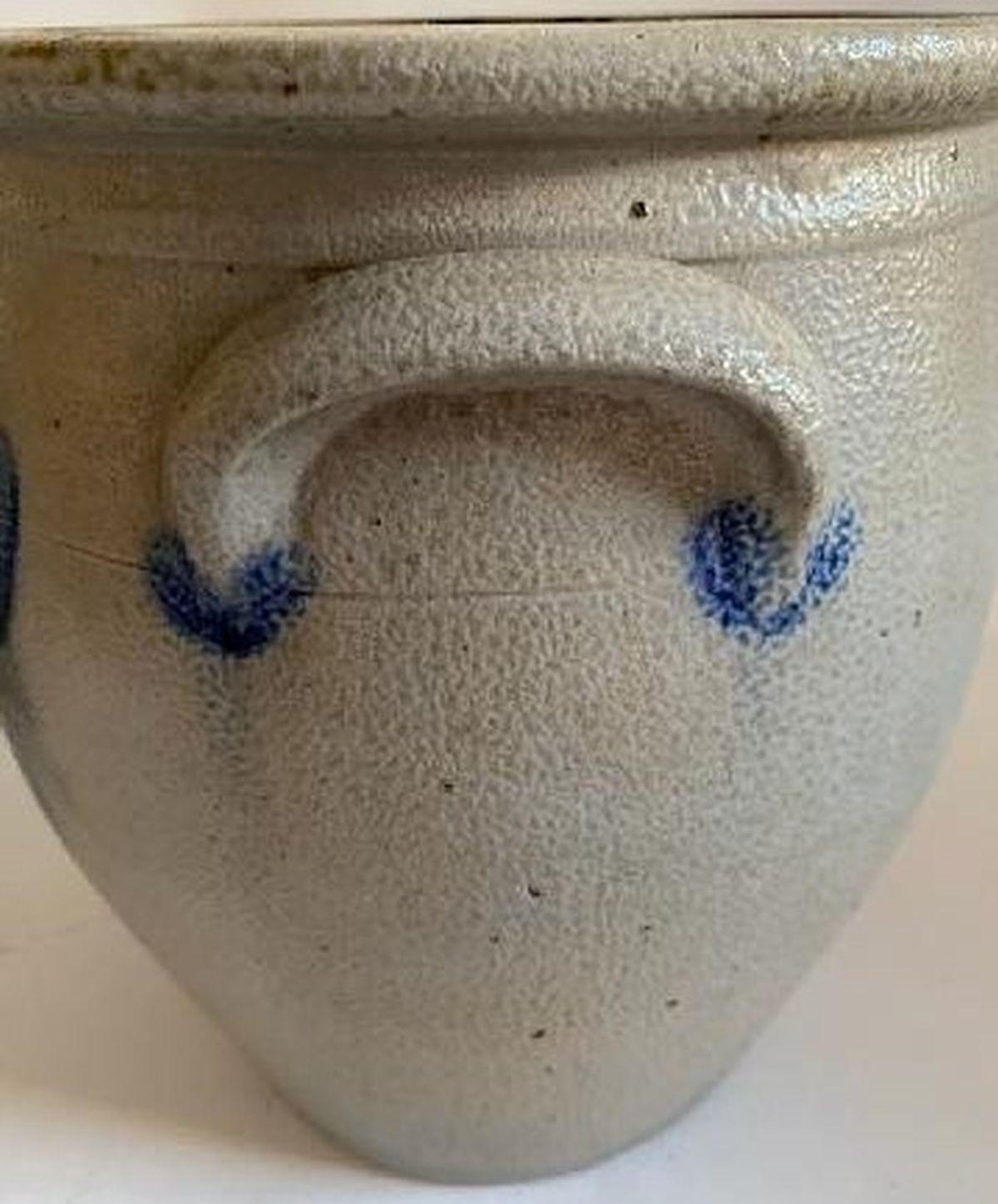 This fine blue decorated hand made pottery crock. It has the original double handles and in fine condition. Minor base chip (tiny). Fantastic glaze surface. This is a large three gallon crock with double handles. It is stamped Sipe & Sons