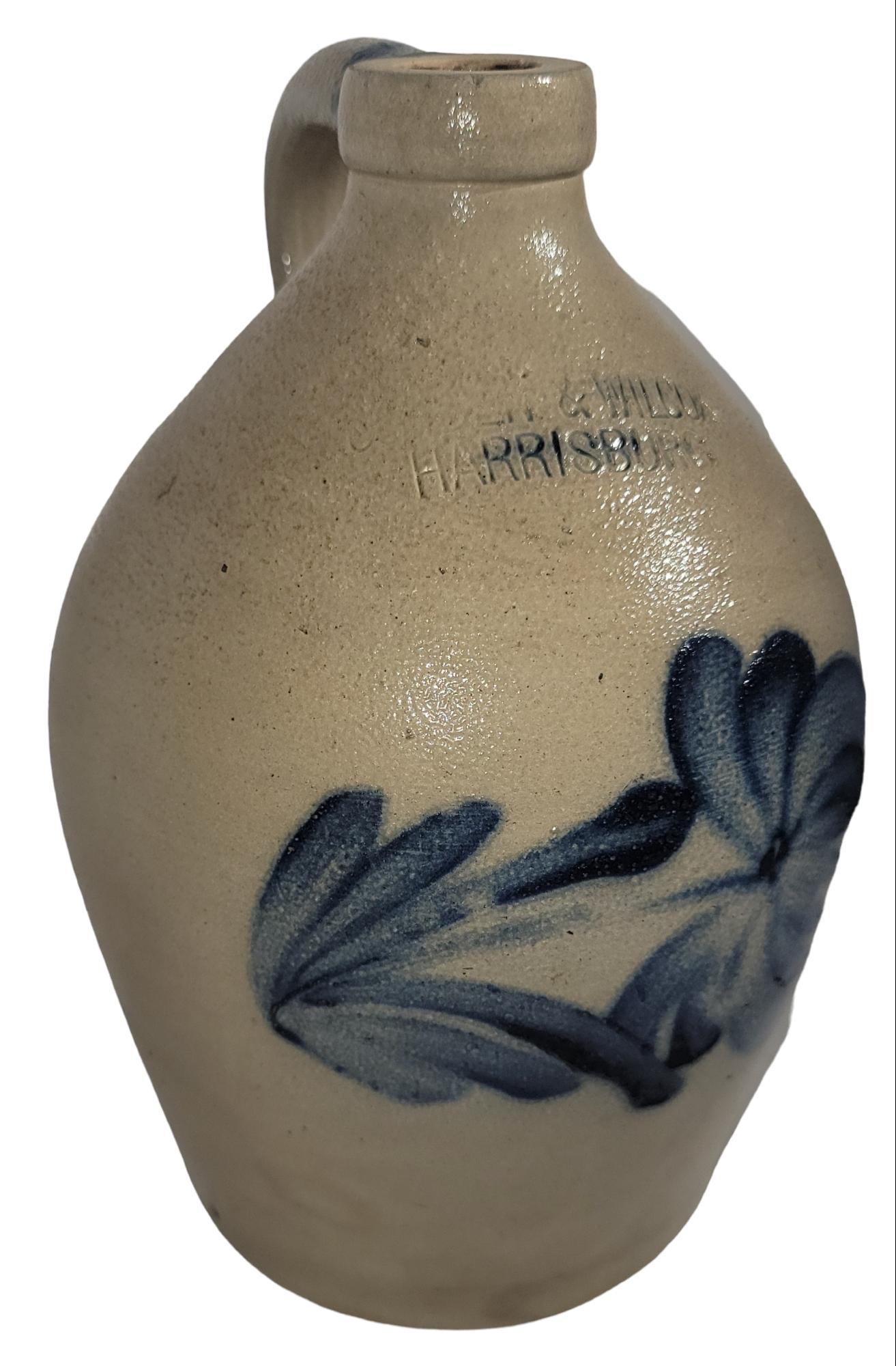 This 19th century hand decorated or painted Cowden & Wilcox jug from Harrisburg, Pennsylvania in fine condition. These decorated stoneware jugs are hard to find in such fine condition.