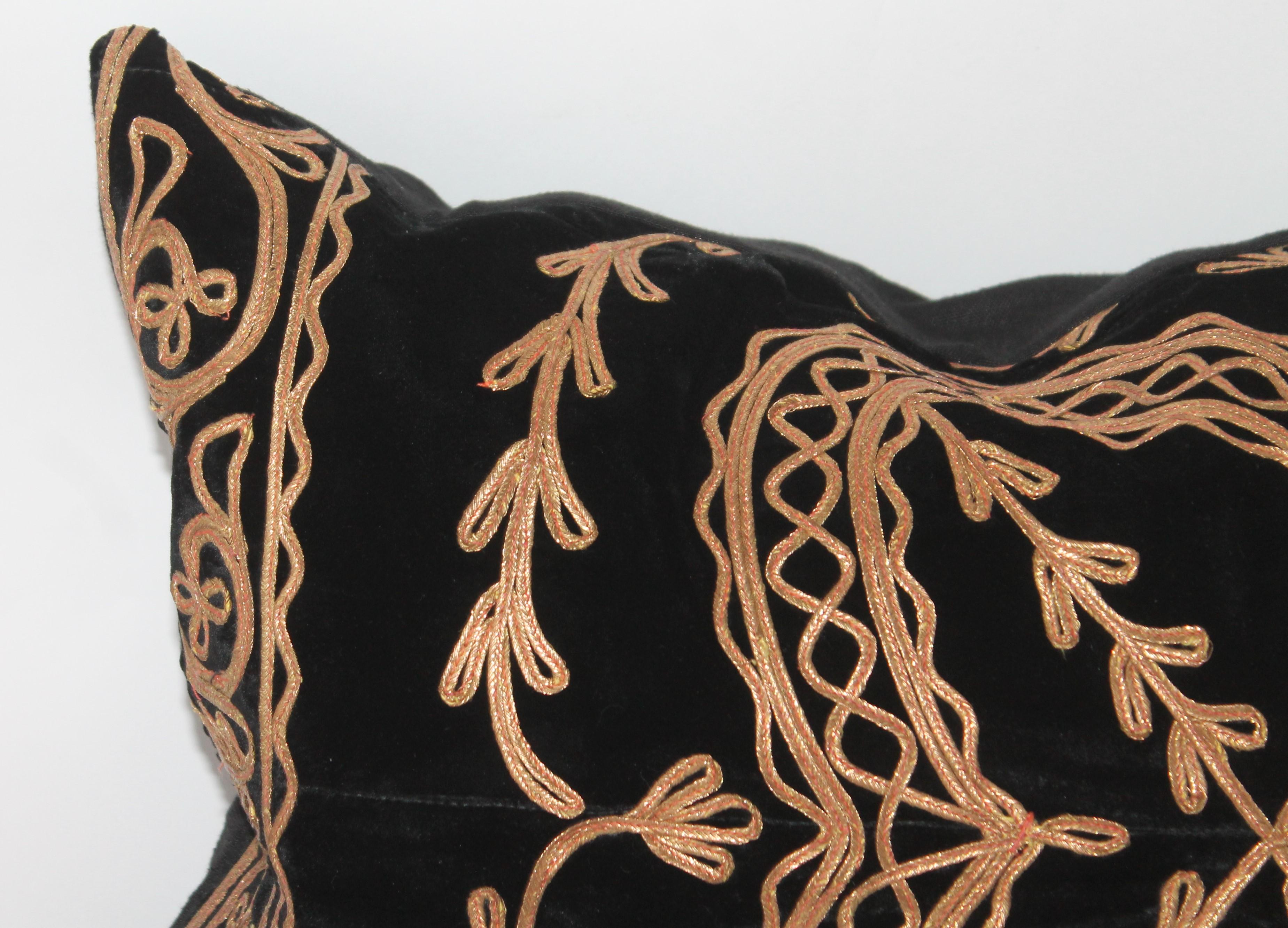 This fantastic early silk black velvet pillow has gilded metal trim throughout. It is in pristine condition. The insert is down and feather fill.