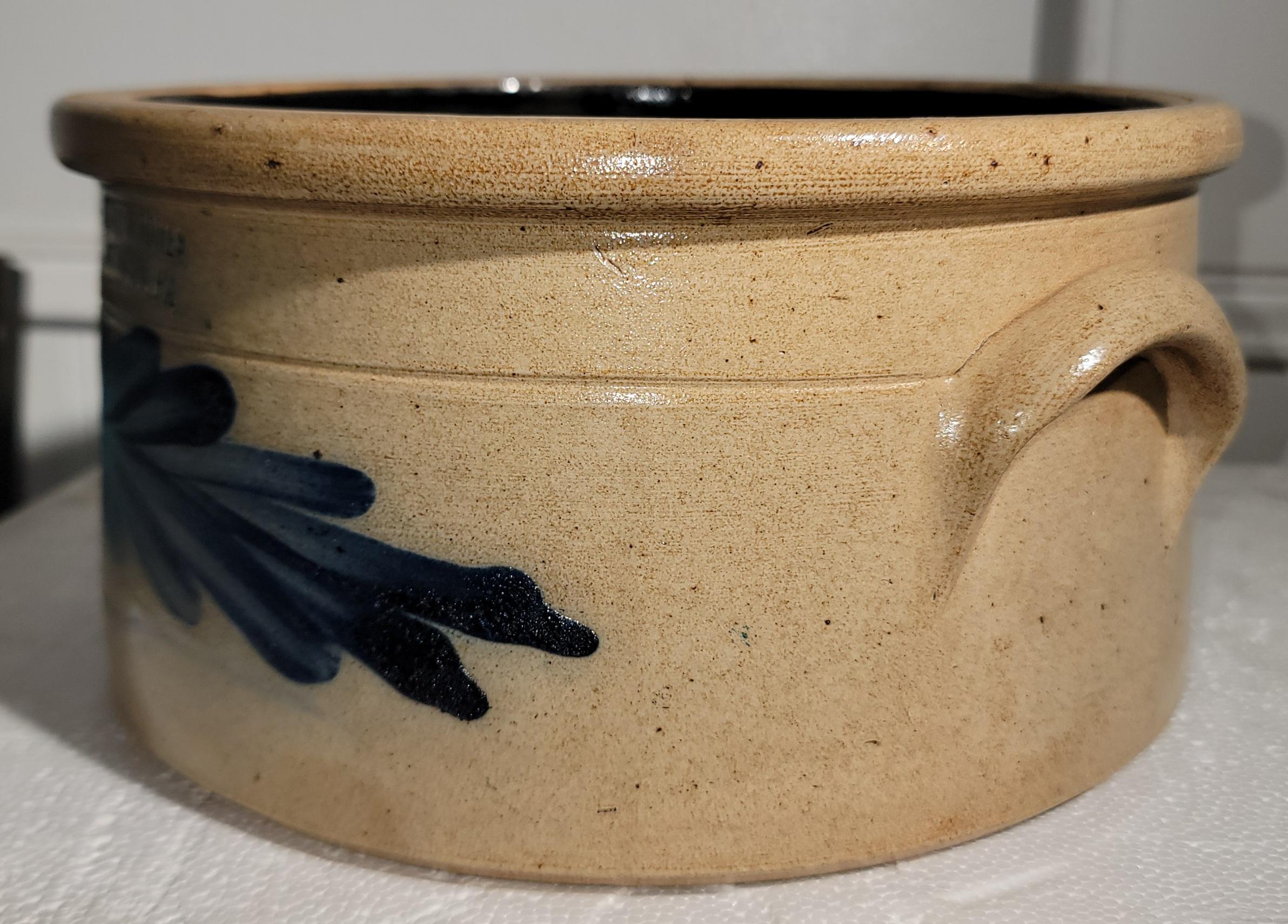 This fine 19thc decorated stone ware cake crock is signed by Evan R. Jones and made in Pittston,Pennsylvania.It has two hand applied handles on each side.This crock is in mint condition.