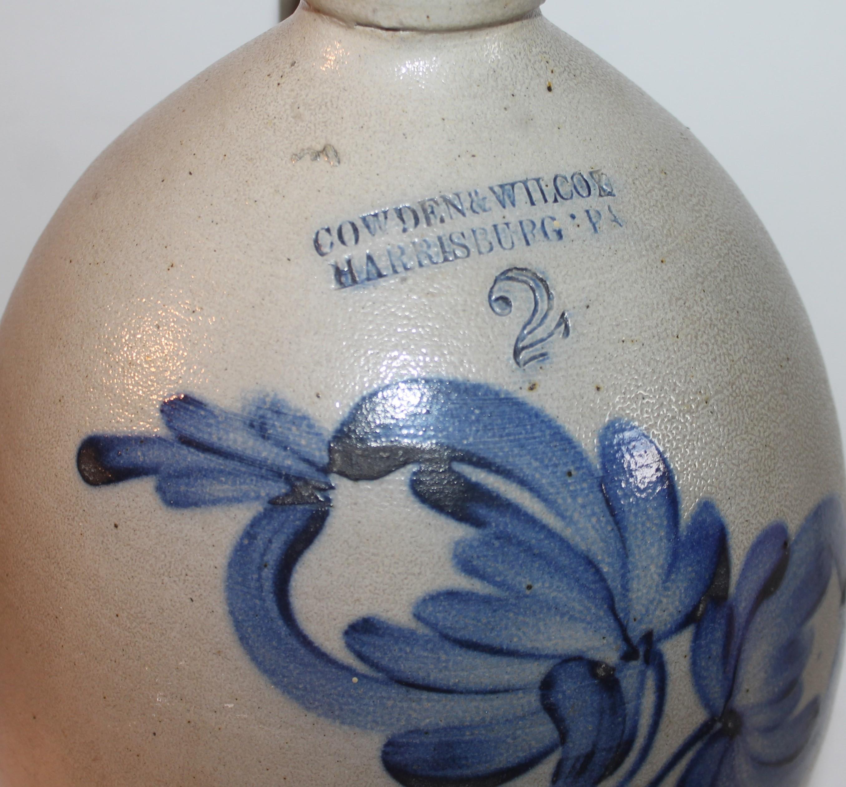 This 19thc original decorated two gallon stoneware jug is in fine condition. It is a Cowden & Wilcox decorated jug from Harrisburg,Pennsylvania. The condition is very good.