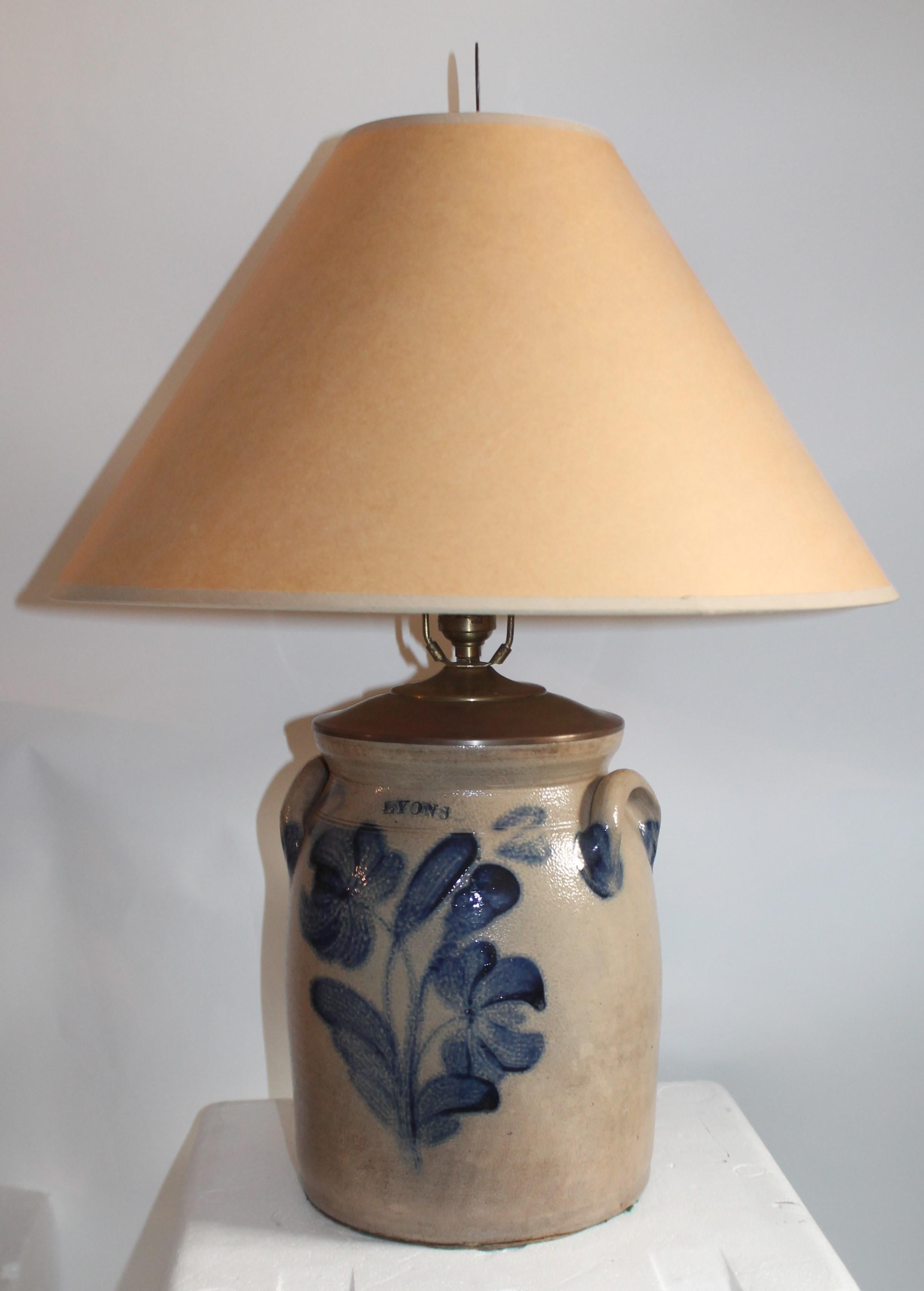This 19th century blue salt glaze decorated flowers crock with double handles and signed 