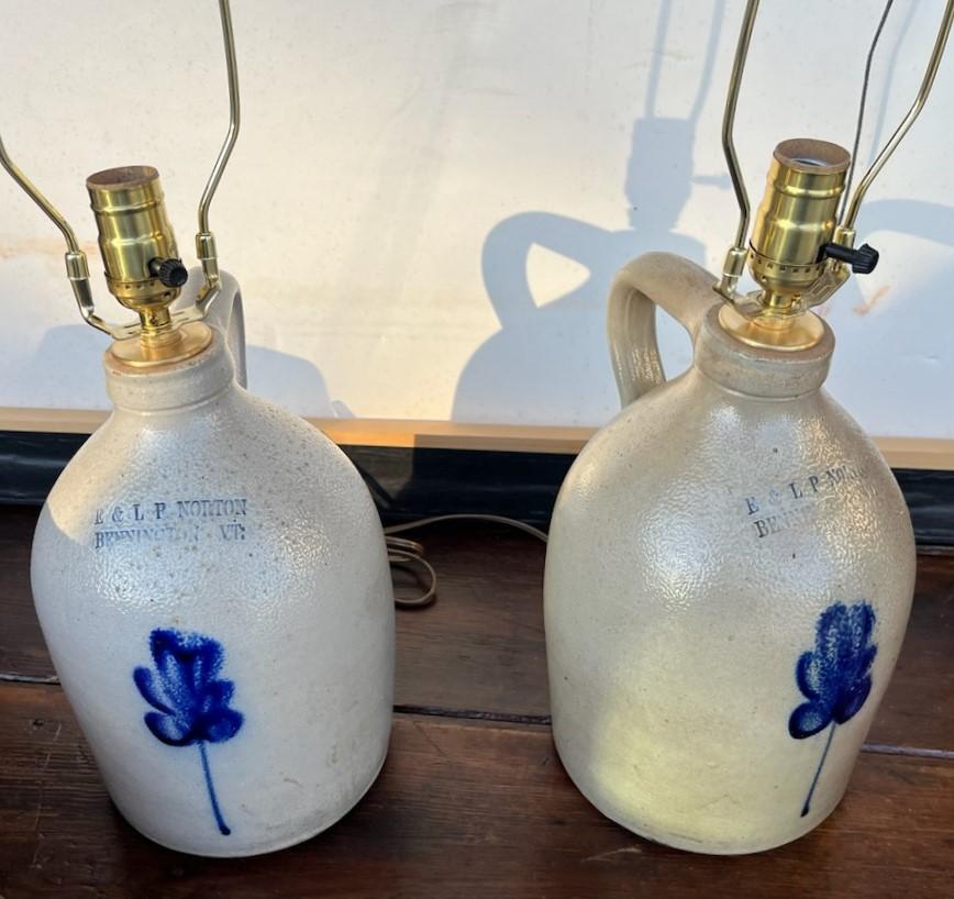 These pairs of decorated stoneware jugs are newly wired for lamps with new linen custom made lamps.Sold as matching pair.Pristine condition.