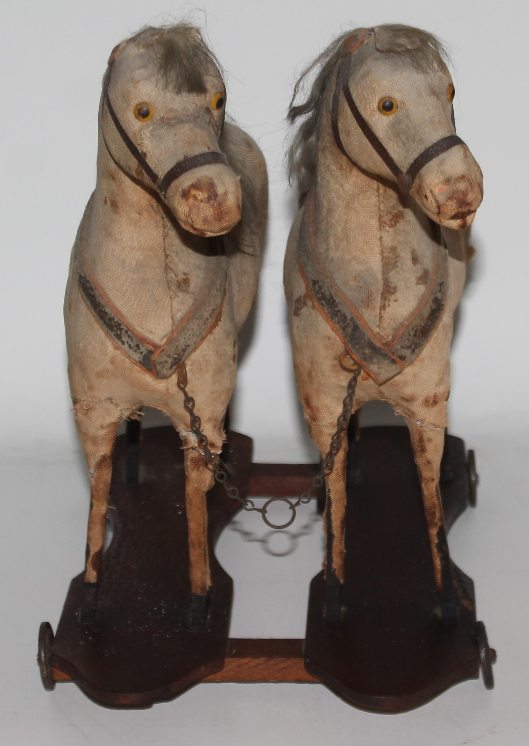 19Thc all original double horse pull toy with original iron wheels and red painted wood base. The condition is worn but in good condition.
