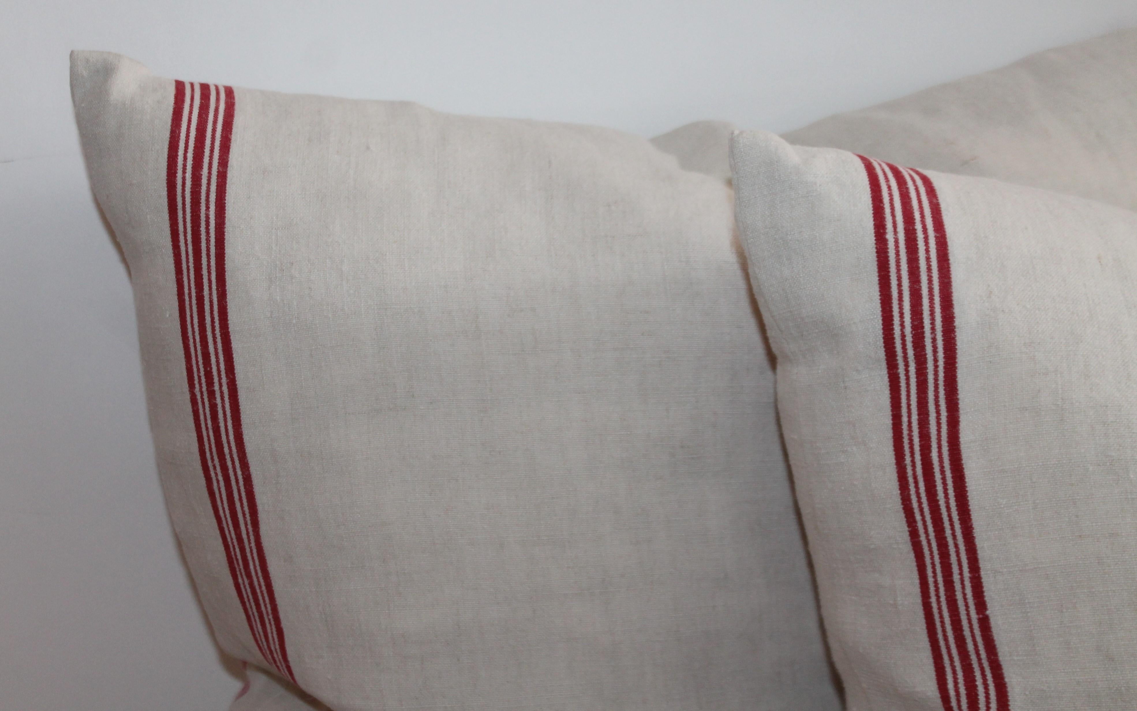 19th century double sided red & white stripped linen ticking pillows. The condition is pristine. Only one pair in stock.