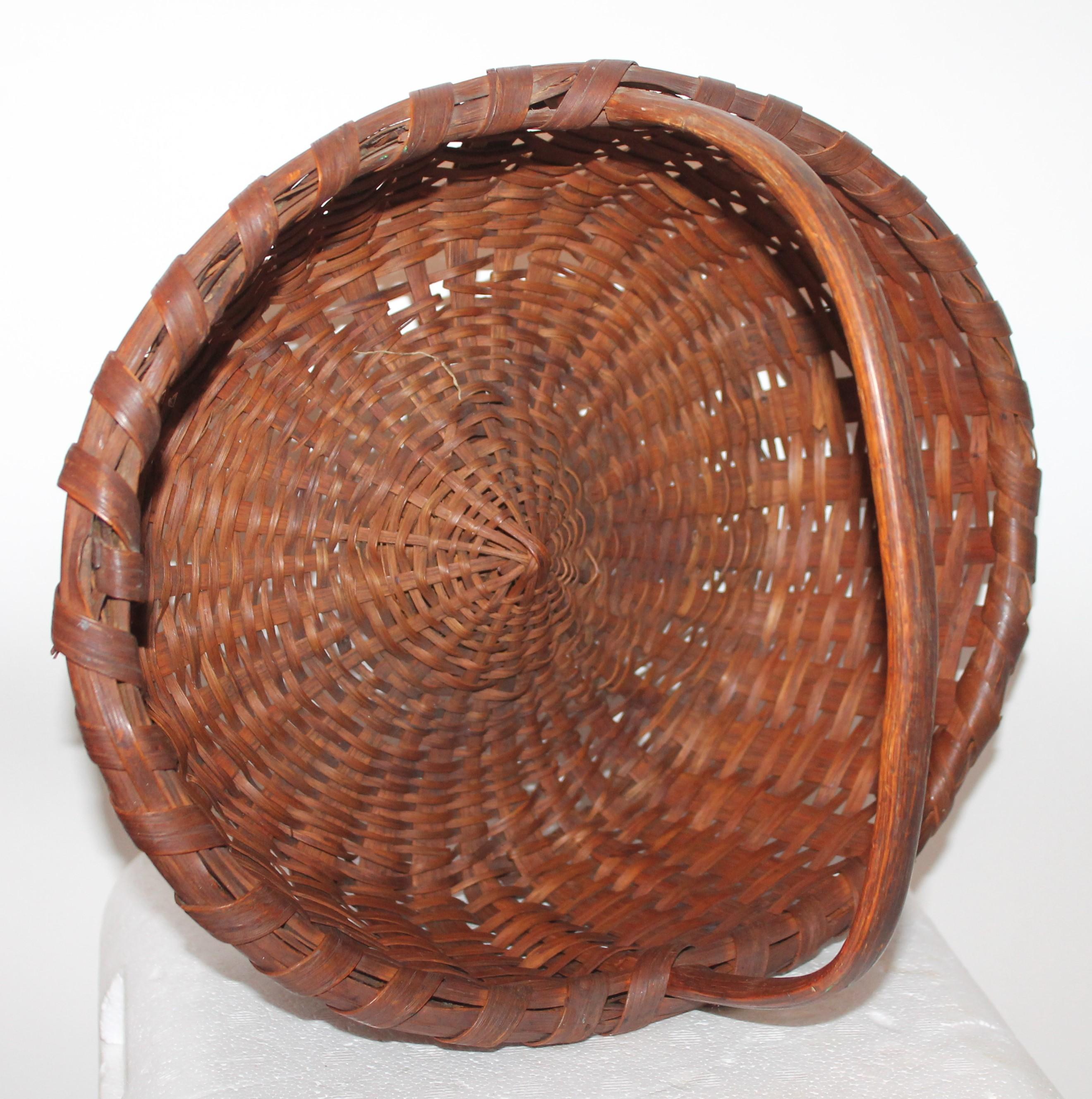 This early mid-19th century basket is in fine condition with minor wear on base but very good condition. The handle is in great shape as well. Found in eastern shore Maryland.