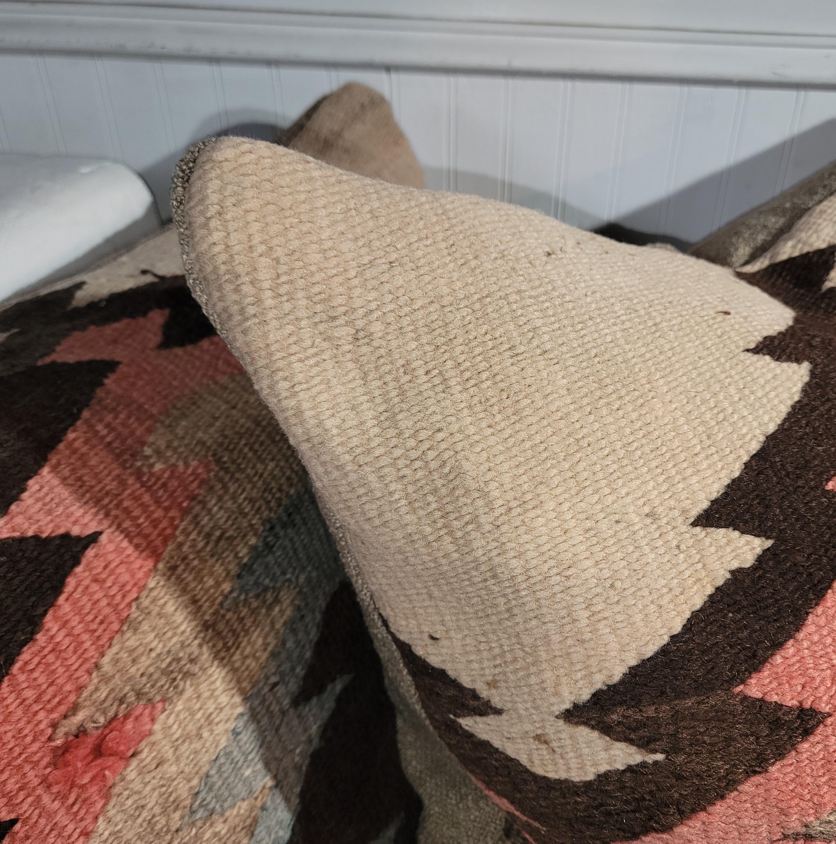 Early 19Thc Navajo Indian weaving pillows in unusual colors of salmon,tan & brown with light blue centers.The back is in a soft wool linen.The inserts are down & feather fill. Sold and priced as a pair.
