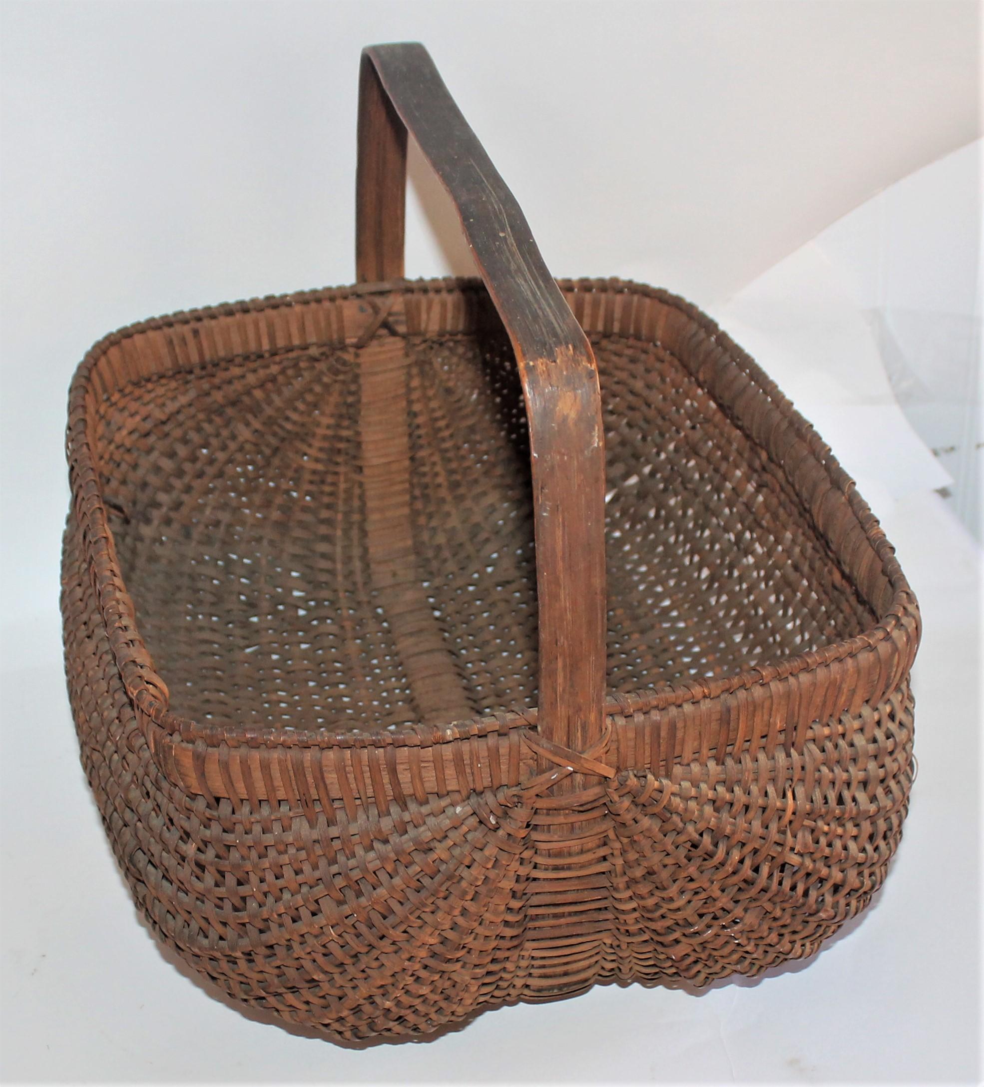 19th century early tightly woven basket with original handle. The condition is very good.