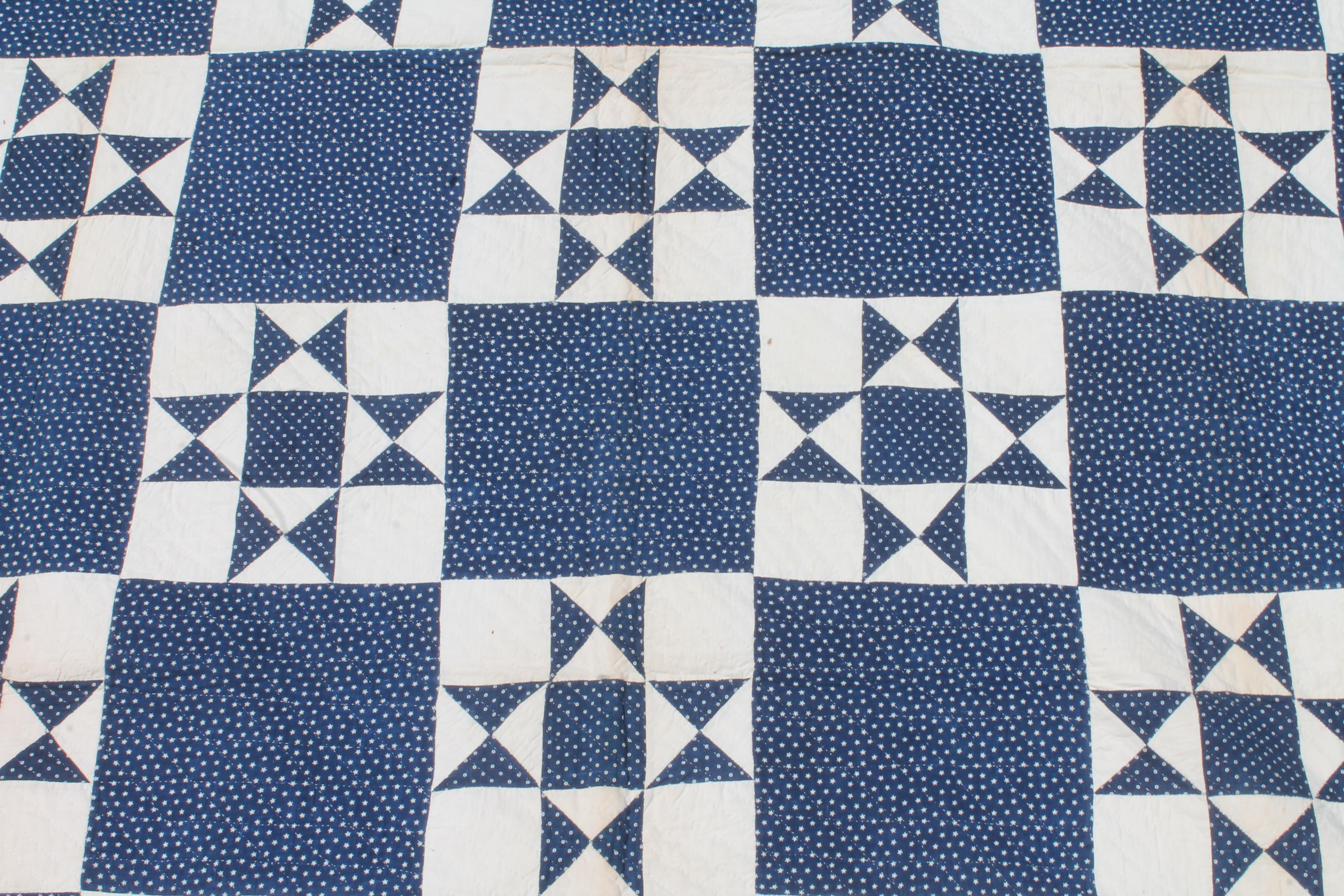 This fine 19thc indigo blue back round quilt in a eight point star pattern is in fine condition. Most unusual blue calico back round fabric.