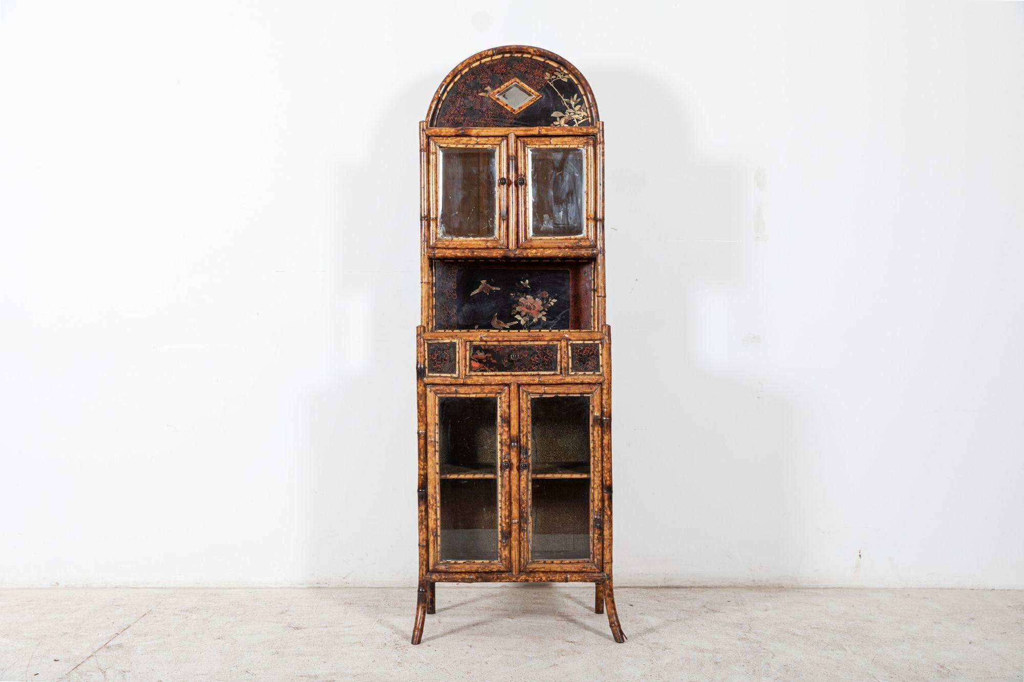Circa 1870

19thC English bamboo Glazed cabinet

A fine unrestored aesthetic movement style etagere cabinet features an arched mirrored glazed cabinet top above a central glazed cabinet with shelved interior, drawer and original papered