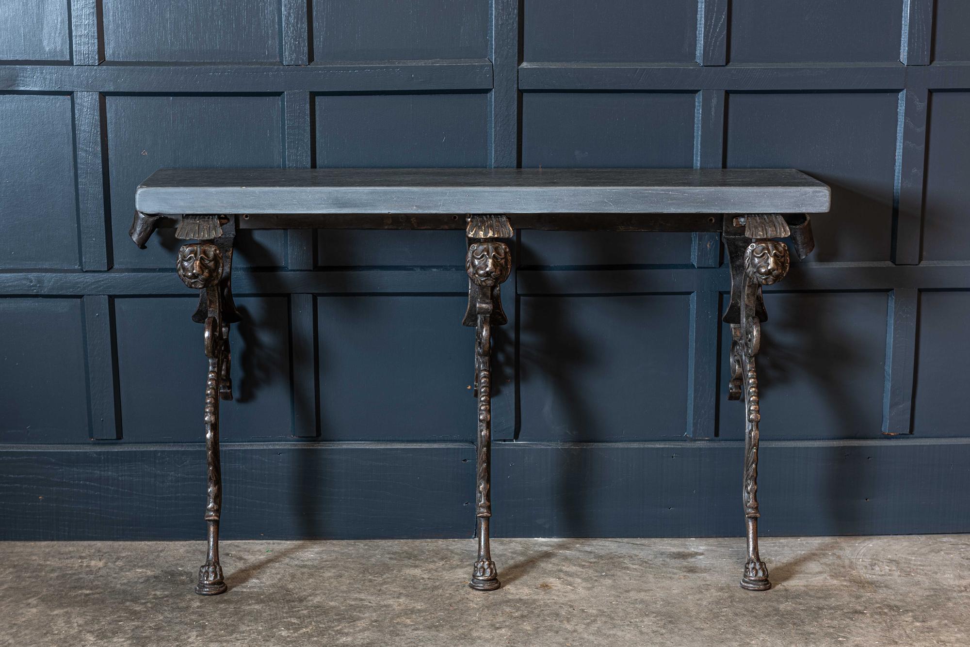 19th century English Coalbrookdale cast iron lion console table,
circa 1880.

A 5cm thick sanded and clear waxed Welsh blue slate top supported on three elaborate Coalbrookdale cast iron polished supports with lion’s heads, acanthus cast detail