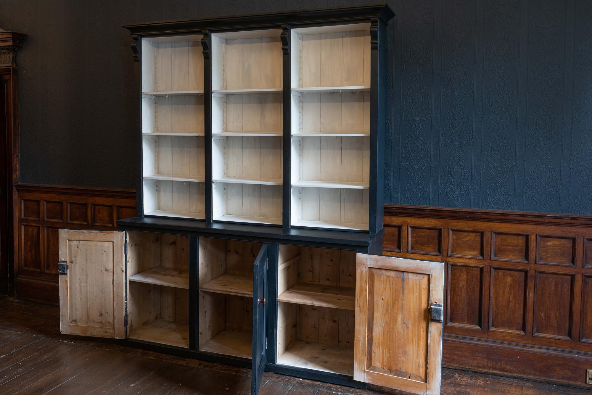 19th century English ebonized black bookcase, dresser,
circa 1890.

Ebonized - pine 3-door 6 sectioned cupboard base and separate top with adjustable shelves.

Good size and scale, a versatile piece of furniture with a shallow