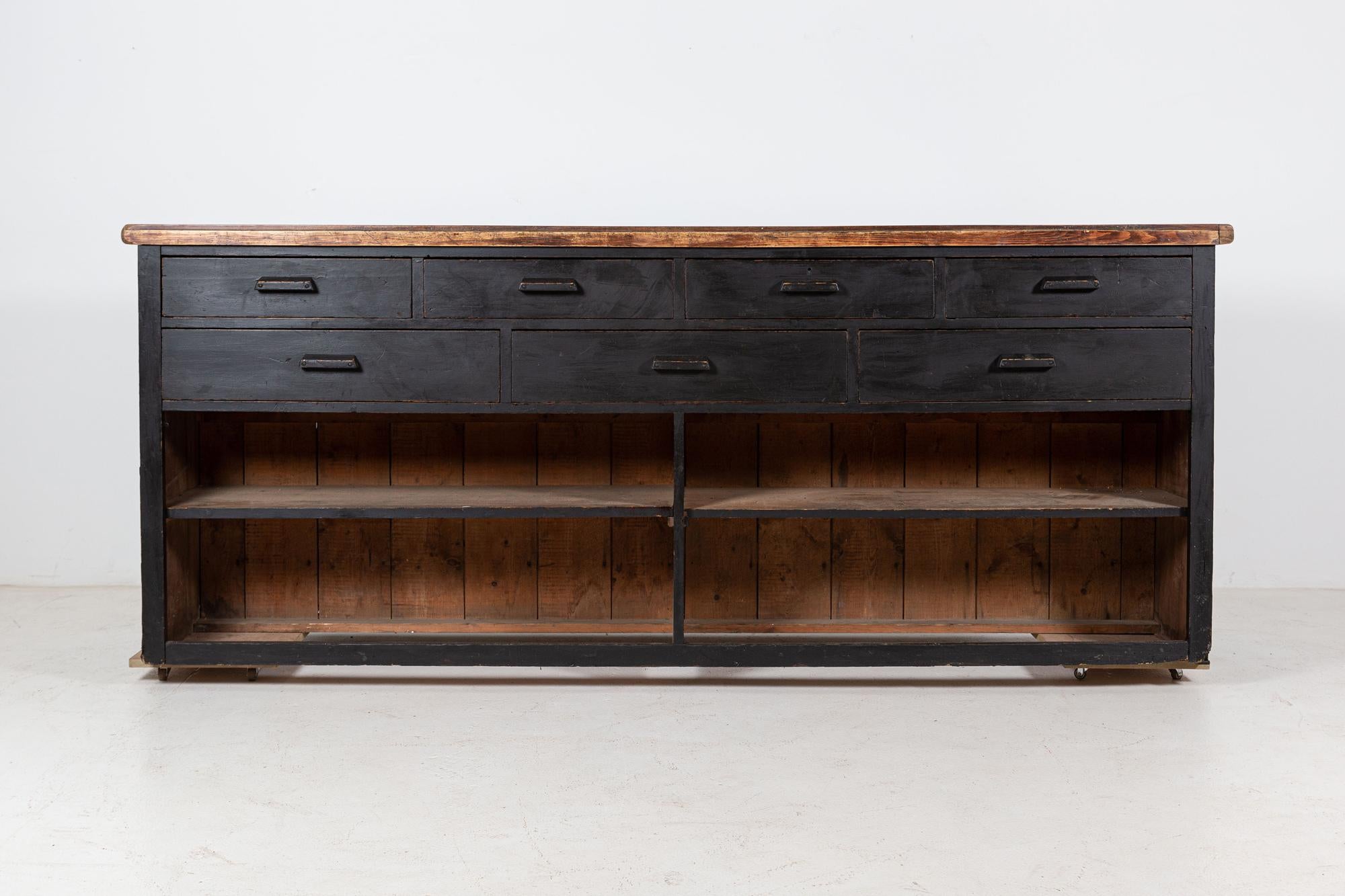 Circa 1890

19thC English ebonized double sided mahogany shop counter

Four glazed doors to the front with internal shelving, original brass latches and recessed handles. Seven drawers to the rear with original wooden handles, original till