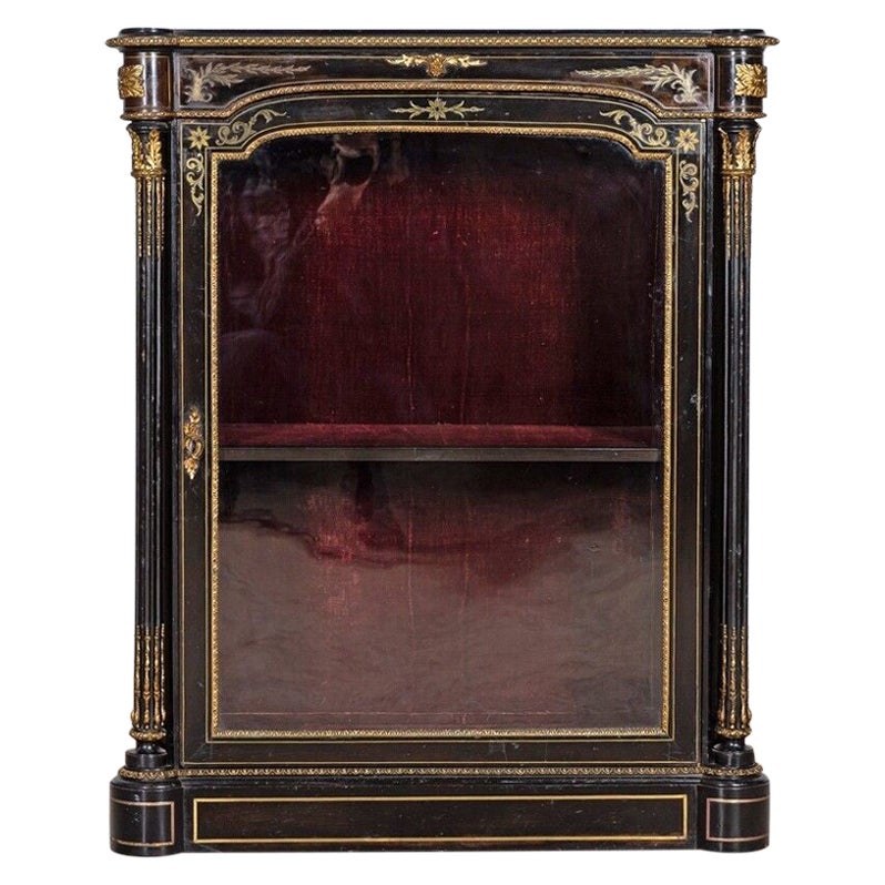 Armoire à piliers vitrée et ébénisée du 19e siècle.