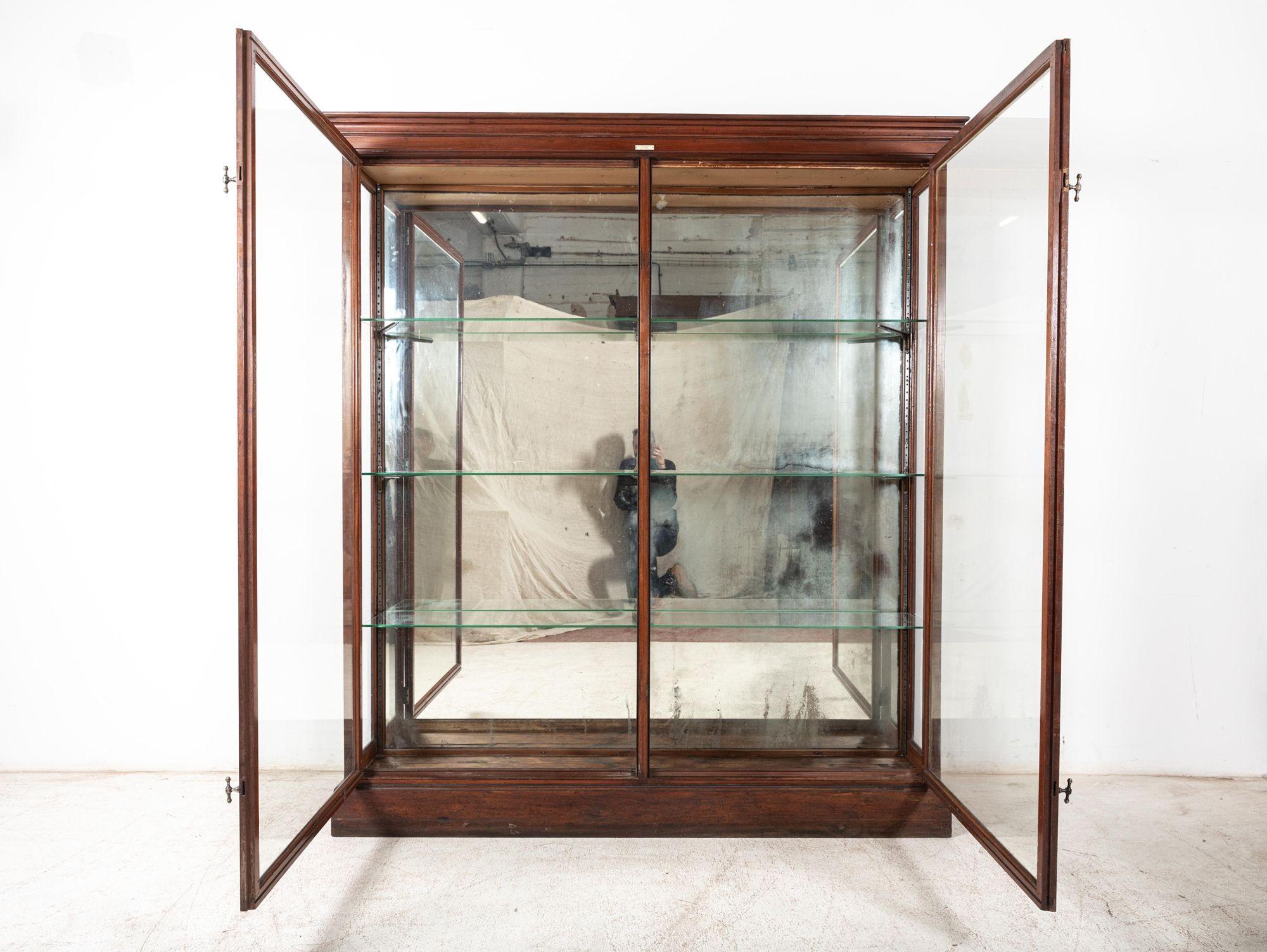 Circa 1890

19th C English glazed mahogany shop fitters display cabinet with original brass T bar handles, foxed mirror, glass shelves & hardware.

Excellent quality by ‘Frederick Maund’ shop fittings of 141 Old Street, London.

Medium