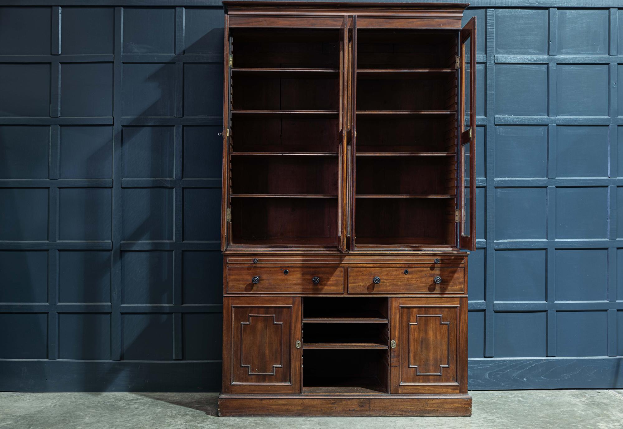 19th century English mahogany glazed secretaire bookcase
circa 1870.

19th century mahogany glazed secretaire bookcase with 4 glazed cabinet doors above a pull out mid section leather writing slide. With 2 large dovetailed drawers, adjustable