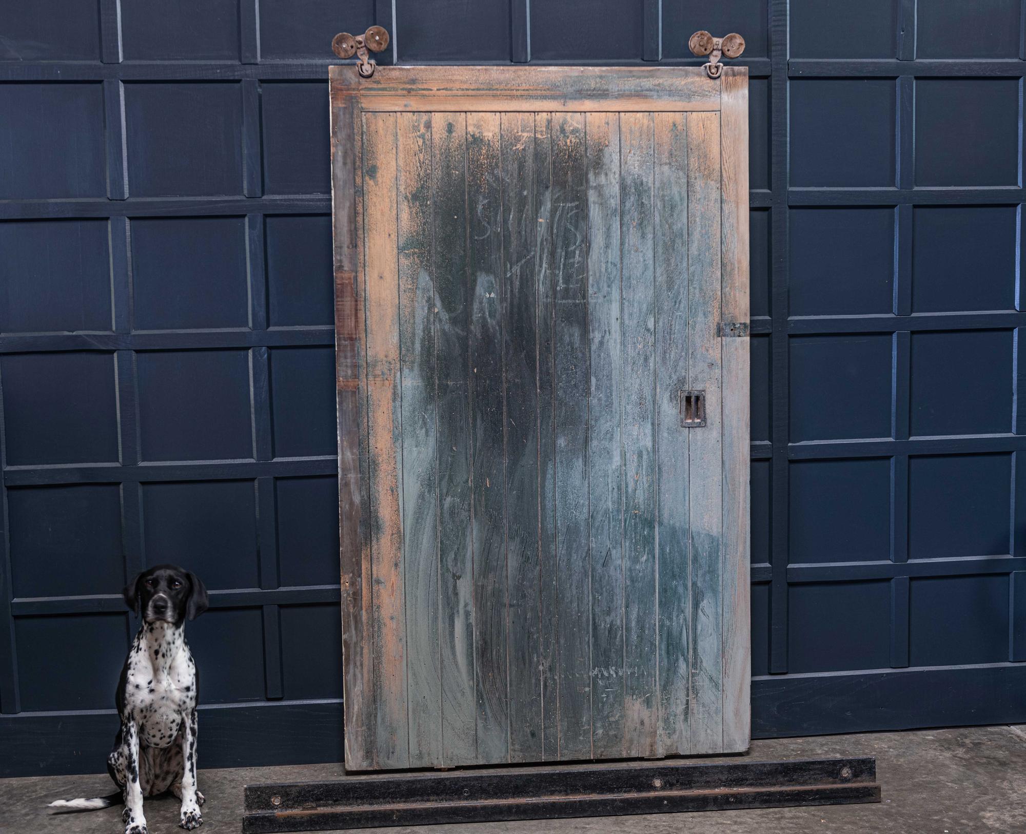 19th century English oversized sliding pine barn door from a North Yorkshire Barn,
circa 1890.

A great statement door with original cast Iron pulley track & ironmongery.

Suited to either residential, commercial or retail scheme.

Measures: