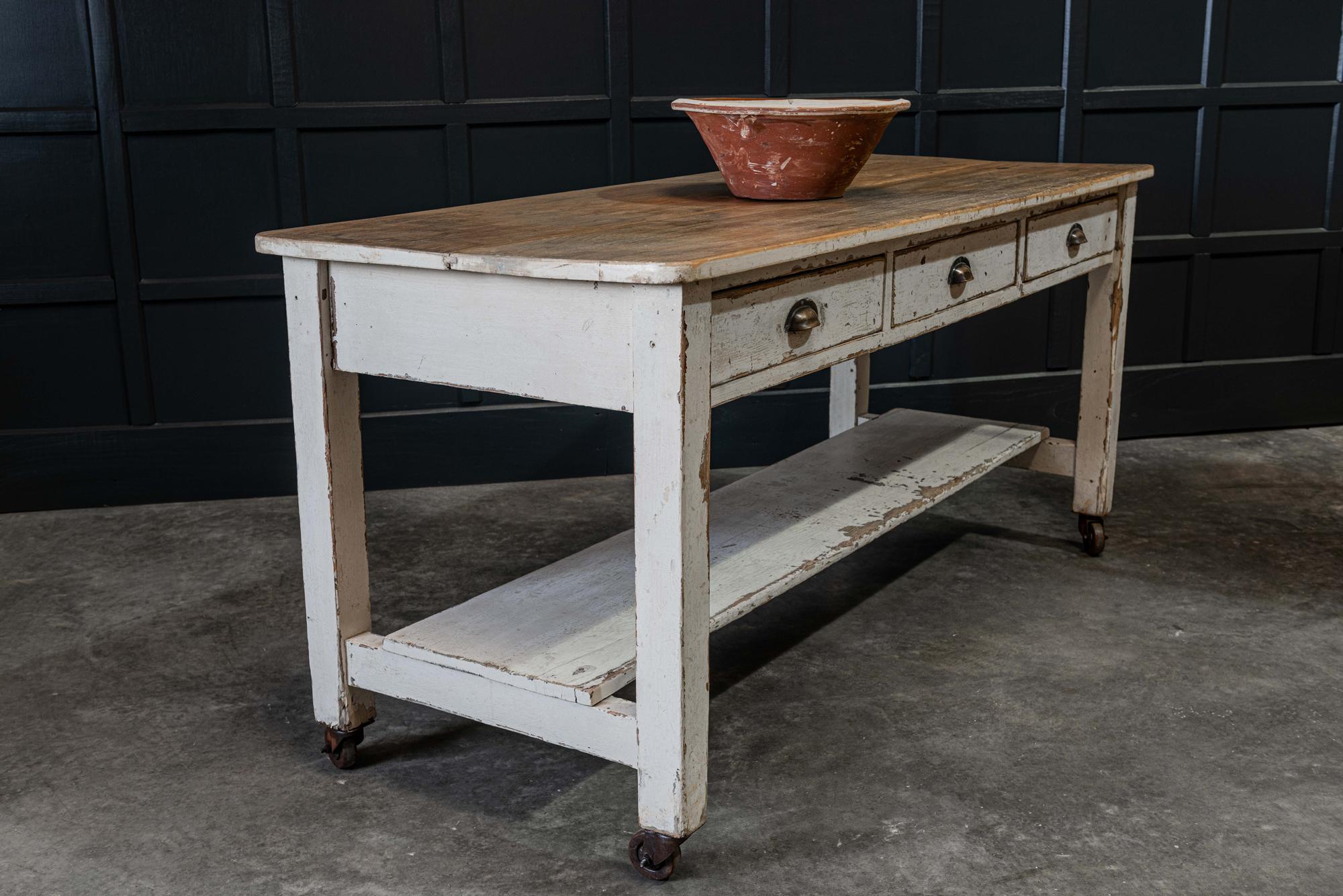 19th century English painted prep table,
circa 1890.

2 plank fruitwood top with pine carcass, three dovetailed drawers above the potboard - sat on later castor wheels. Lovely wear color and size-ideal as a Kitchen Island.

Measures: H 85 x W