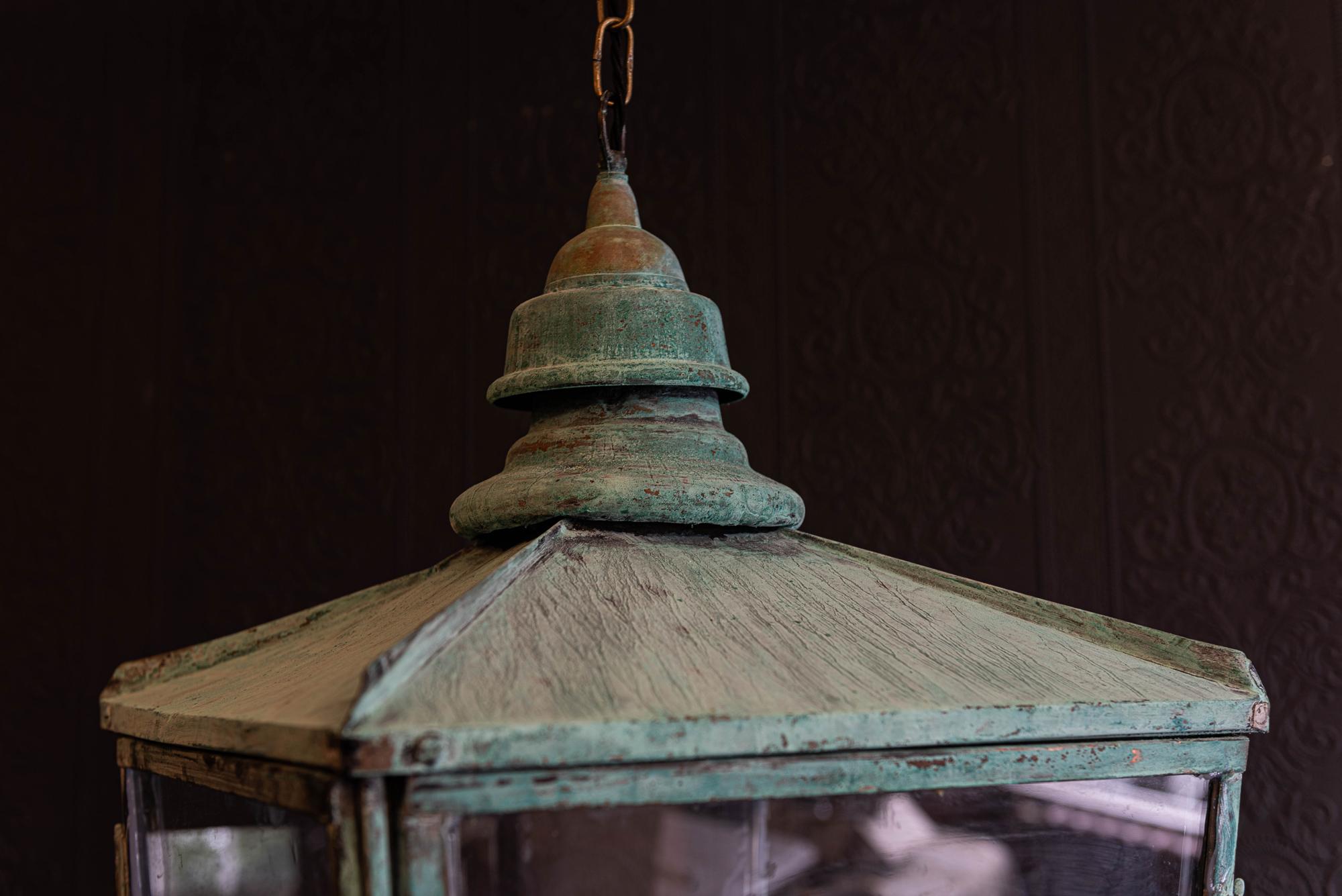 19th century English verdigris copper lantern,
circa 1890.

Two hinged doors

Comes with 1m of silk flex, 1m of heavy gauge antique brass chain and bronze ceiling hook

Re-glazed rewired and pat tested - ready to hang.

Measures: W 42 x H