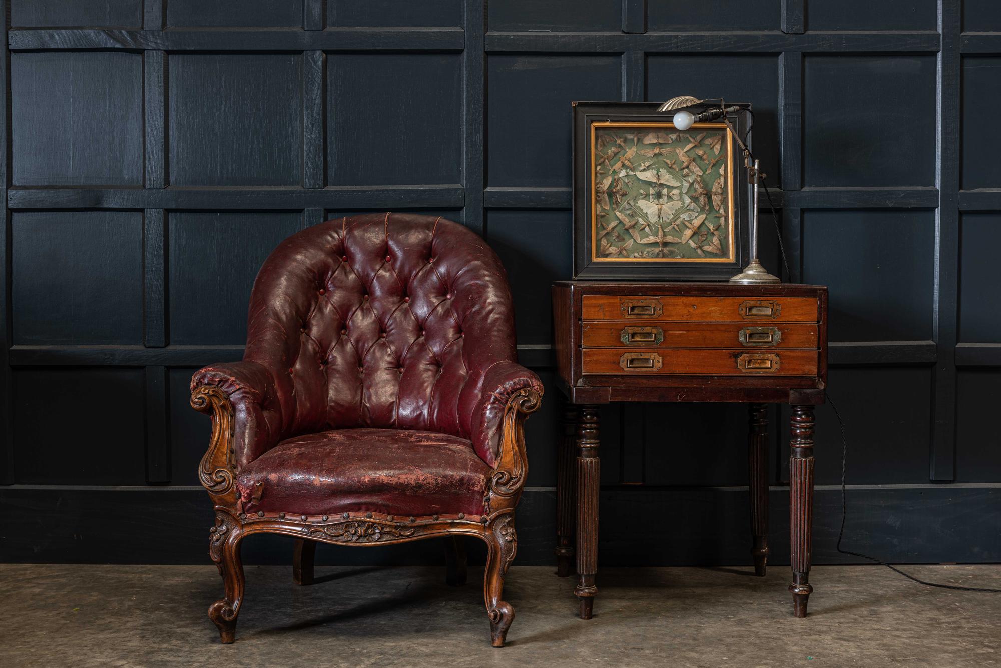 19th century English walnut buttoned library armchair
circa 1870.

With original maroon leather cloth upholstery with old cloth tape patches which improves the character and story.

Measures: H 91 x W 75 x D 80cm
Seat height 40cm.