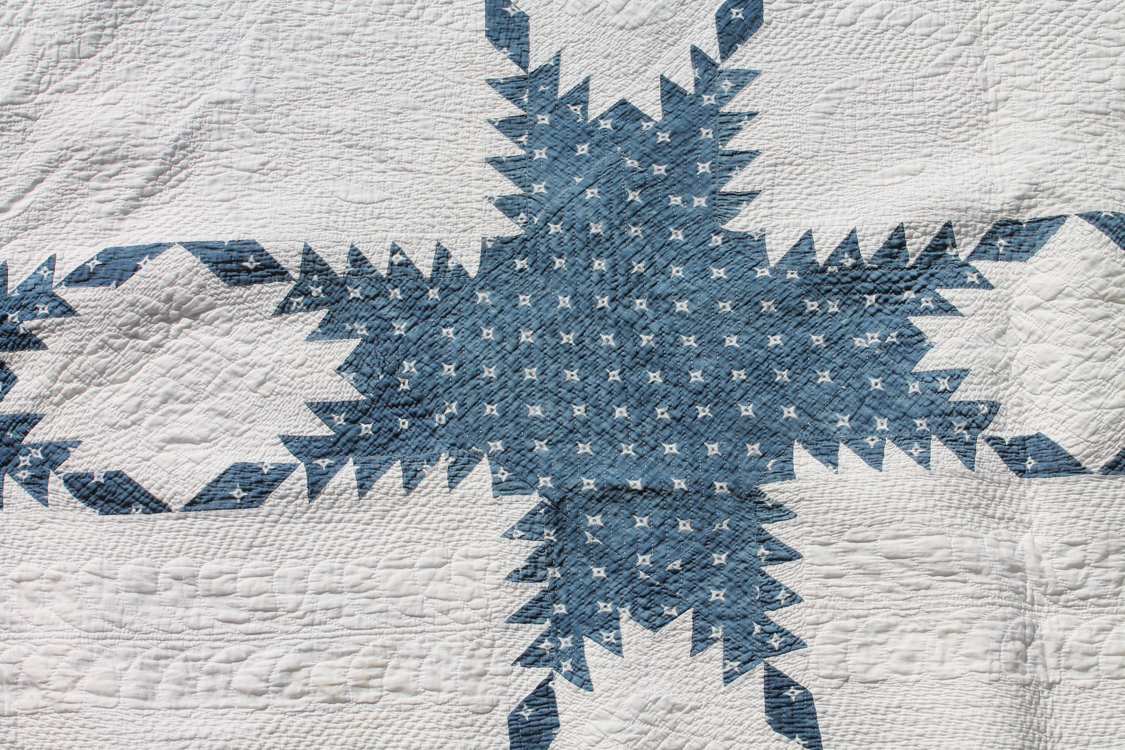 19thc fine blue & white feathered star quilt from Ohio. The quilt has fine piecing and quilting. Detailed quilting looks like stippled quilting.