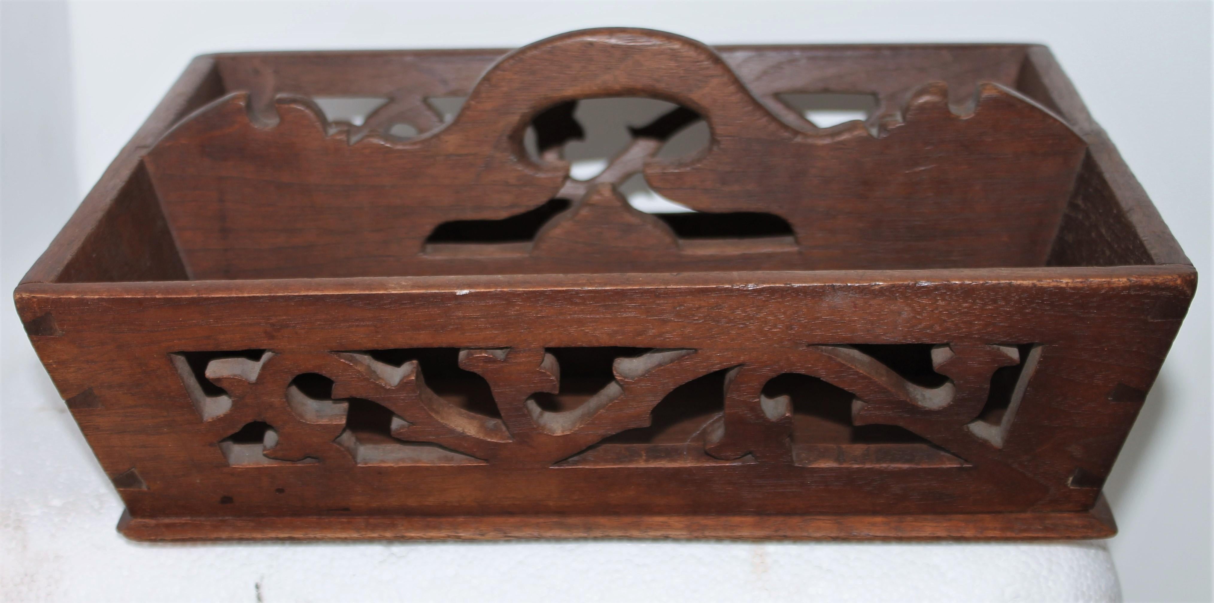 This fine walnut cutlery carrier has great cut outs and in very good condition. This New England carrier is very well made and fine details.