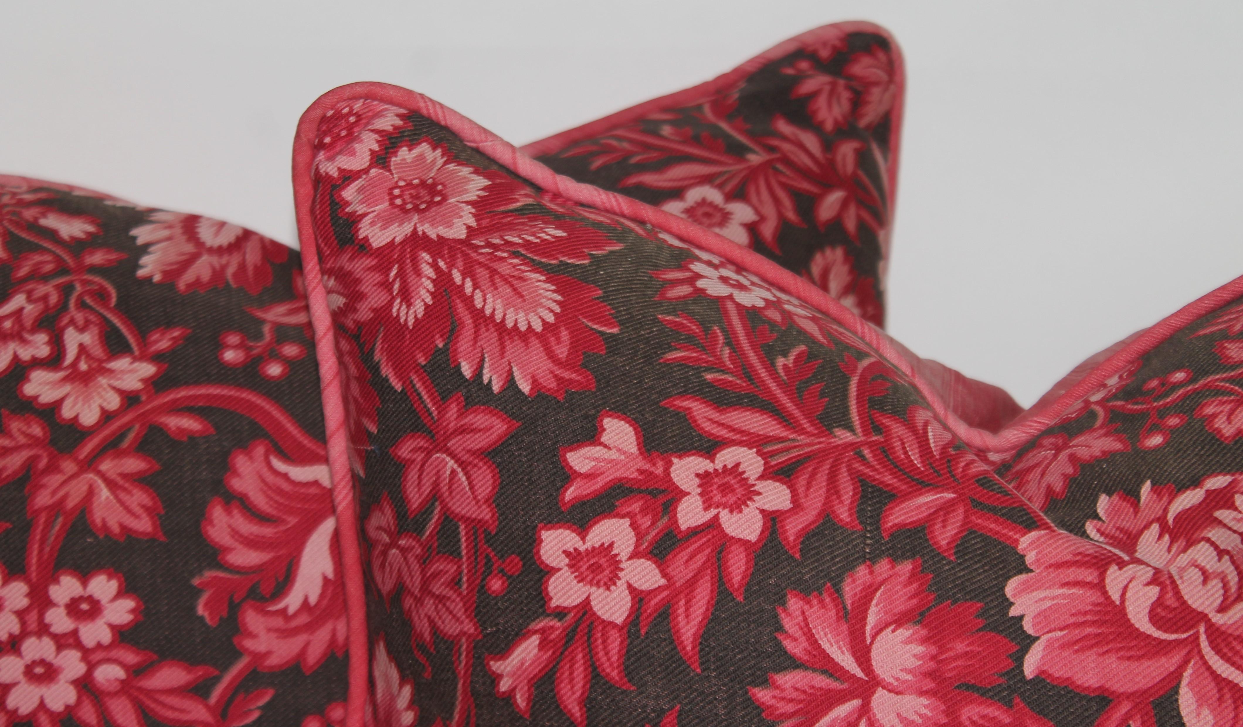 19th century floral and striped ticking fabric pillows. The inserts are down and feather. The backing is in faded mauve stripe ticking.