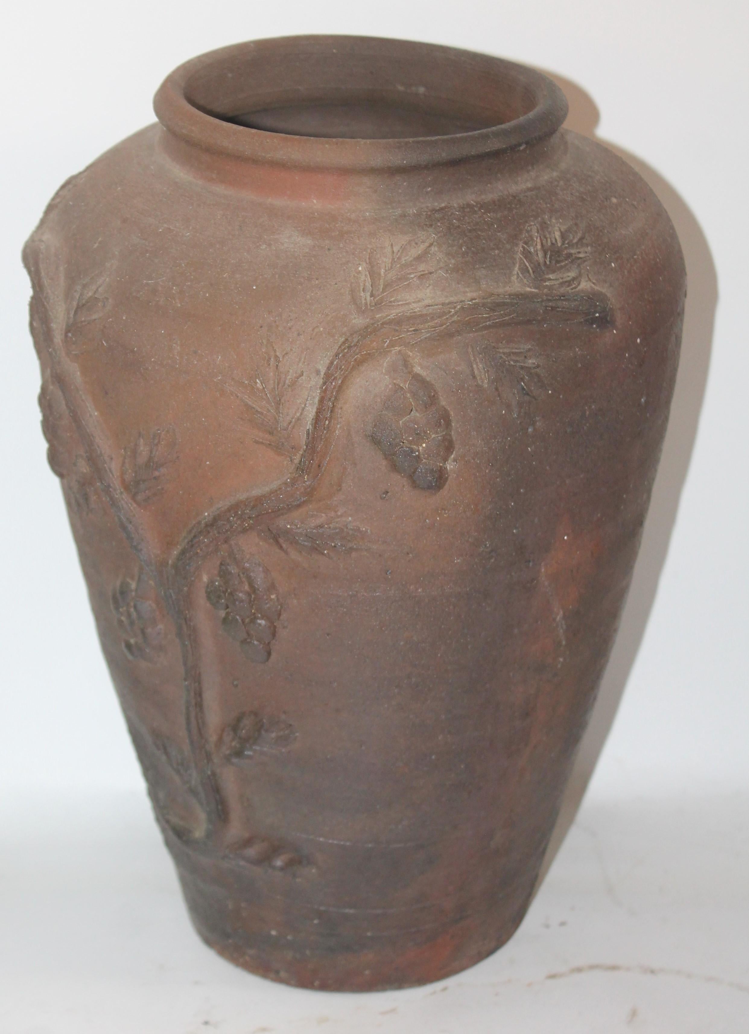 This folky signed red clay or red ware pottery grape vine vase. This tall handmade pottery vase is in very good condition.