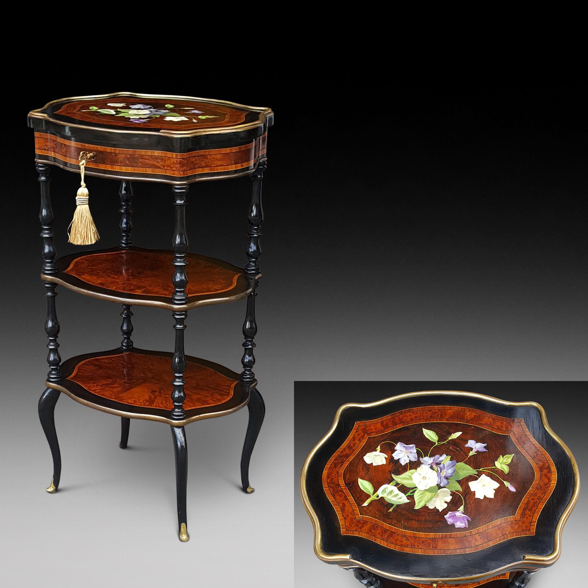 19th century French satinwood crossbanded burr yewwood and ebonised etergere vanity table with porcelain inlaid floral hinged top, revealing a mirrored interior; on turned columns and splayed feet 17.5