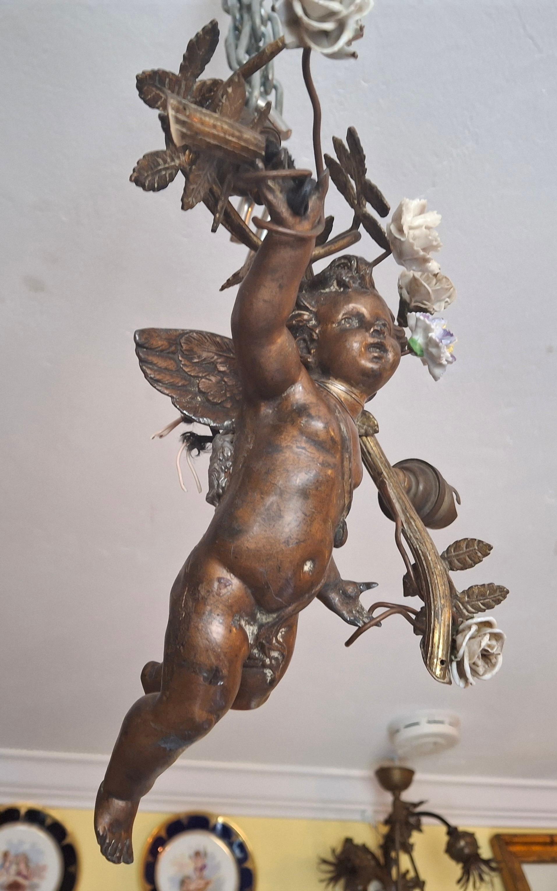 c1890 French Antique Napoleon III Heavy Cast Spelter and Bronze Flying Cherub with His Porcelain Flowered Garland. 3 lights. Beautiful detailed Cherub. Adjustable chain height. Estate find.
