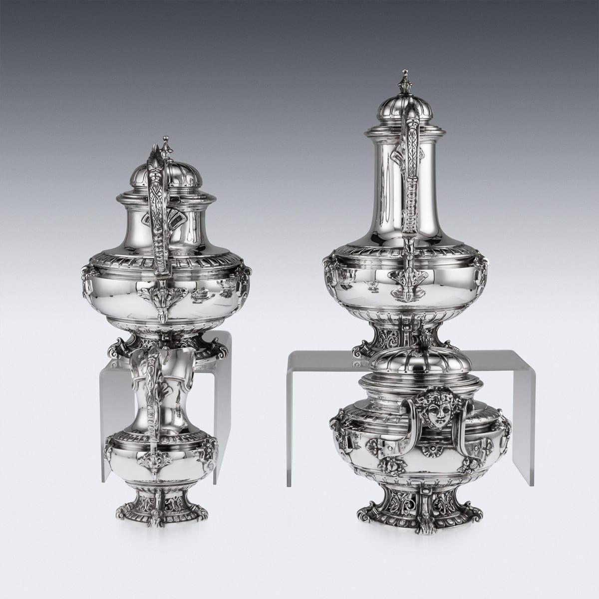 Antique late 19th century French Empire style exceptional solid silver four piece tea service, consisting of a coffee pot, teapot, lidded sugar bowl and cream jug, all on very elaborate and pierced spreading scroll foot, the body applied with masks,