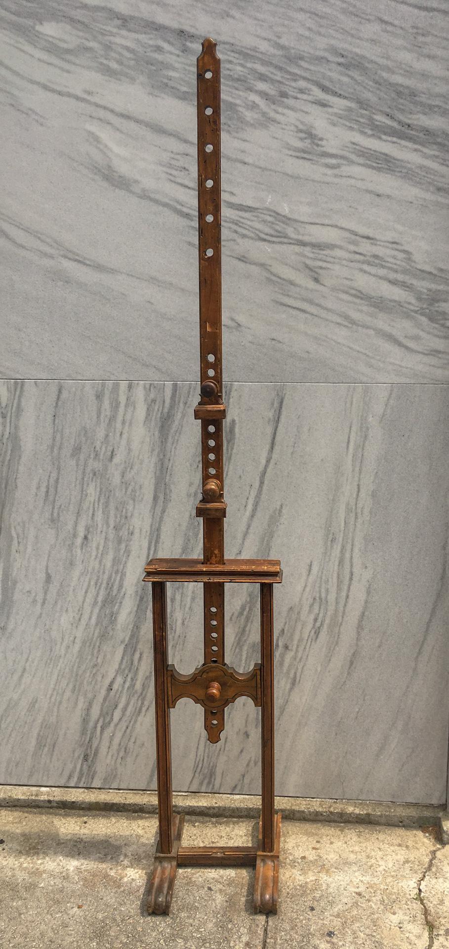 This well used antique fruitwood artist’s easel features an adjustable twenty-four hole mechanism and is raised up on a trestle base terminating in rounded fluted double feet on either side. Well-worn but sturdy with nice old patina. 