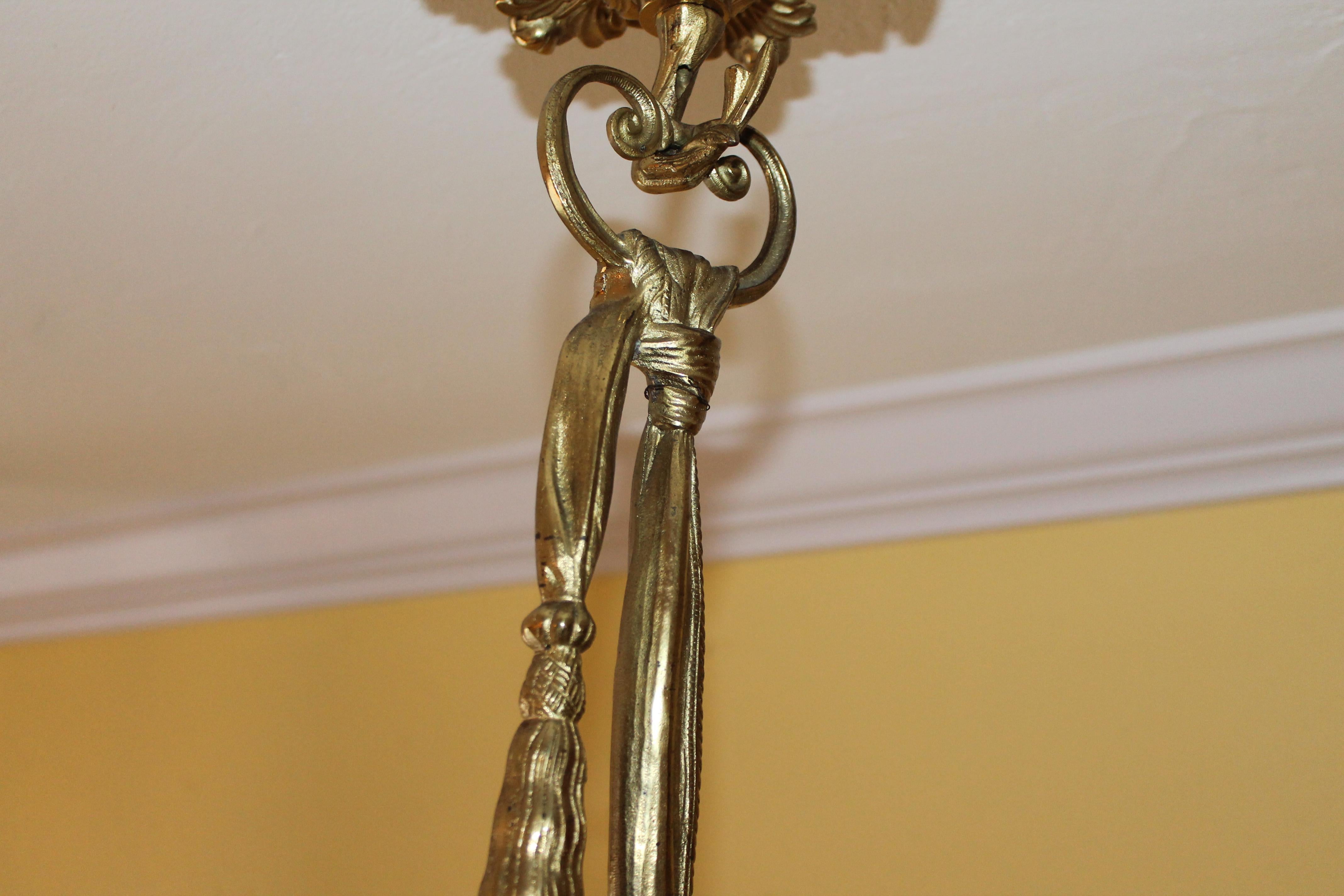 Please look at picture number two as that shows the top tassel detail that is not showing on the main picture. On offer 19thc French Louis XVI Gilt Bronze Gas Converted to Electric Chandelier. This is a heavy piece. Floral detail with center fabric