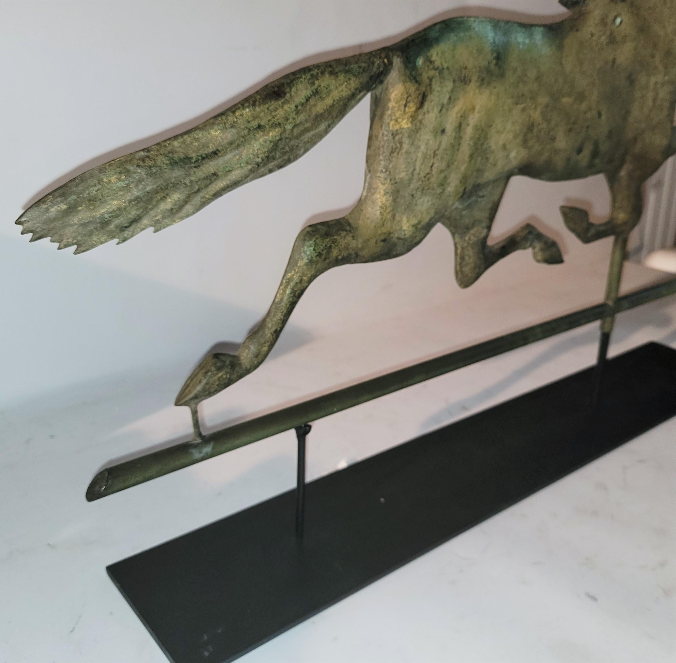 19thc Full body copper horse weather vane with original gilded surface. The condition is good with bullet marks but not holes. This vane comes to us from a private collection in New England. It also has the original custom made cast iron base.