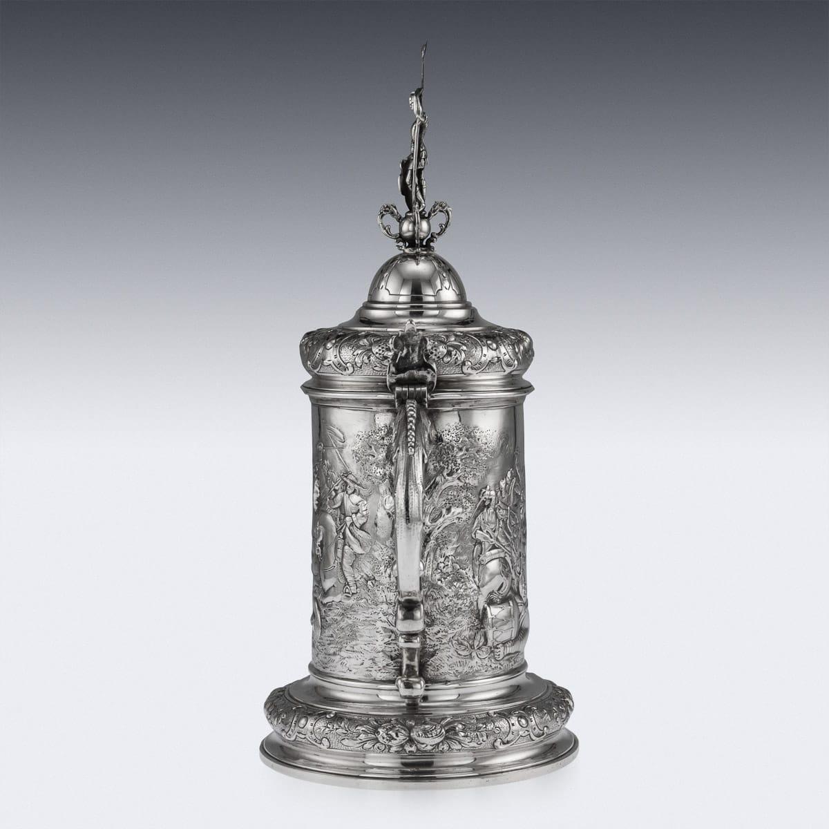 Antique late 19th century German (Hanau) solid silver large lidded tankard, in the style of the early 16th century example, beautifully chased and embossed with a very detailed and crowded battle scenes, the base decorated with scrolling foliage and
