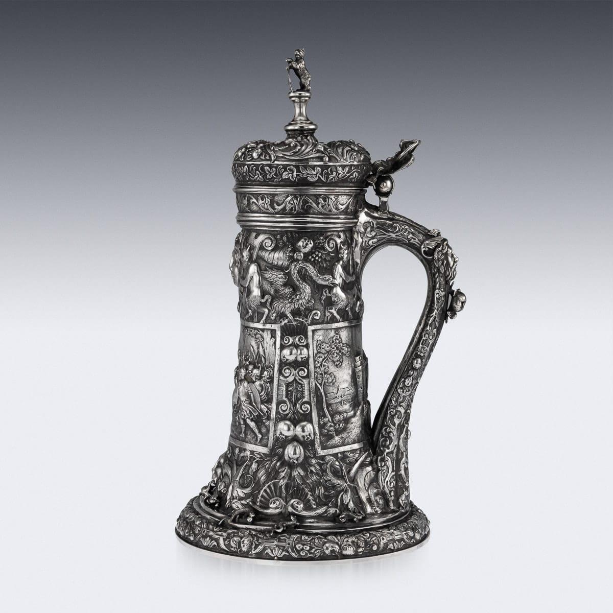 Antique mid-19th century exceptional & impressively large German (Hanau) solid silver lidded tankard, in the style of the early 16th century examples, the front beautifully chased and embossed with a very detailed crowded battle scenes, reverse