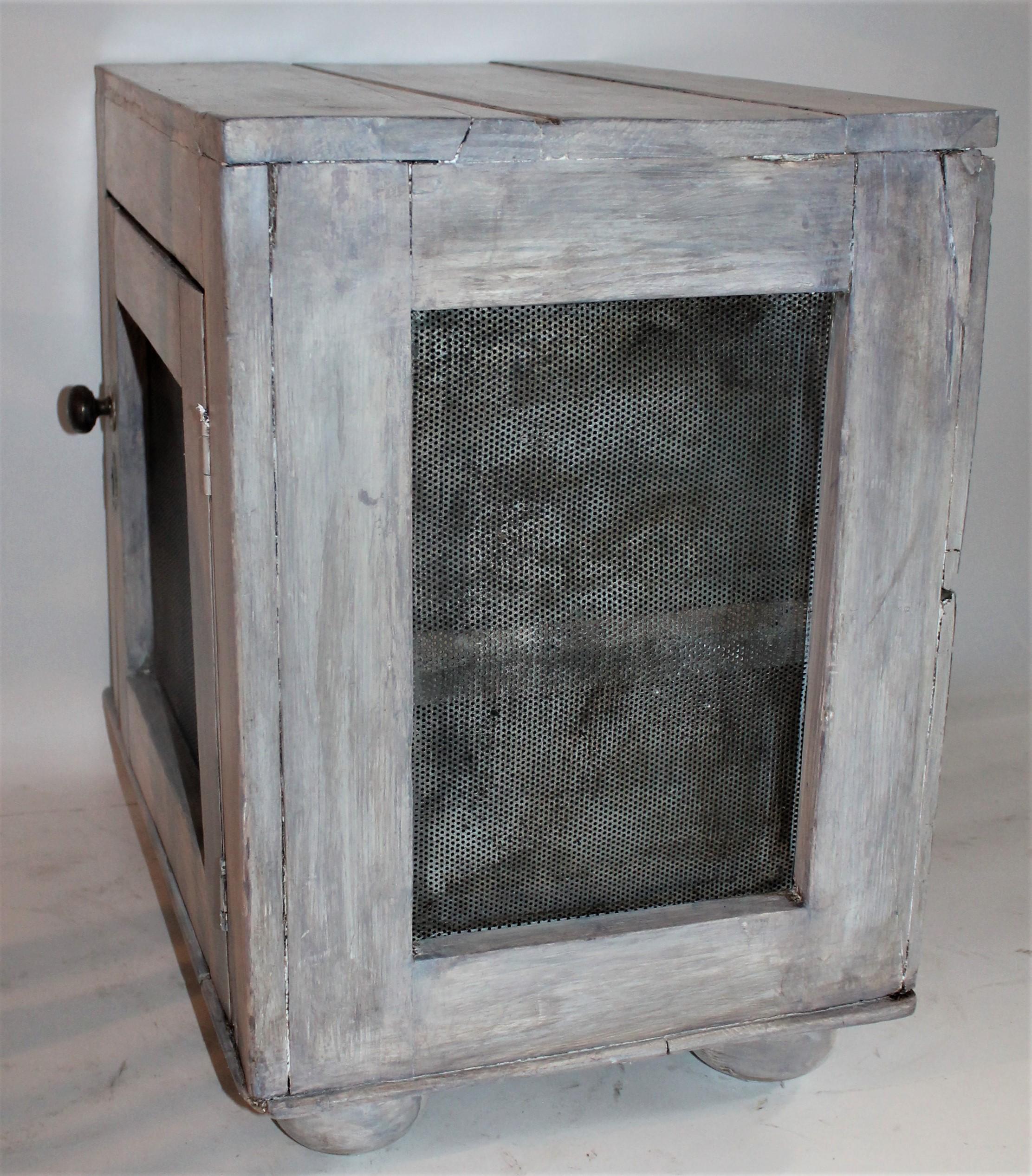 This old grey painted small scale tabletop pie safe was found in the mid-west and is in good condition. Great scale and form. All original screens and hardware.