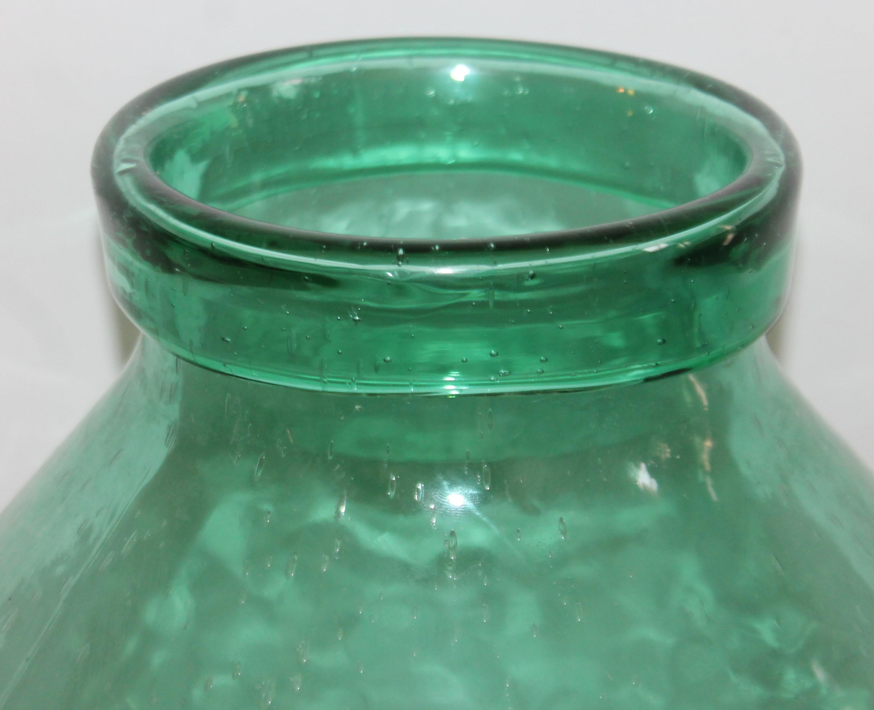 This fantastic hand blown storage jar is in fine condition and has a curled under lip. Lots of bubbles and pontil on base.